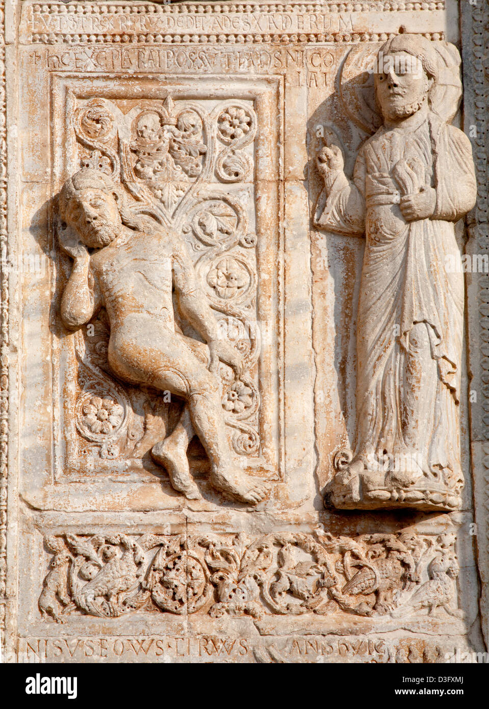 VERONA - JANUARY 27: Relief of creation of Adam from romanesque Basilica San Zeno. Stock Photo