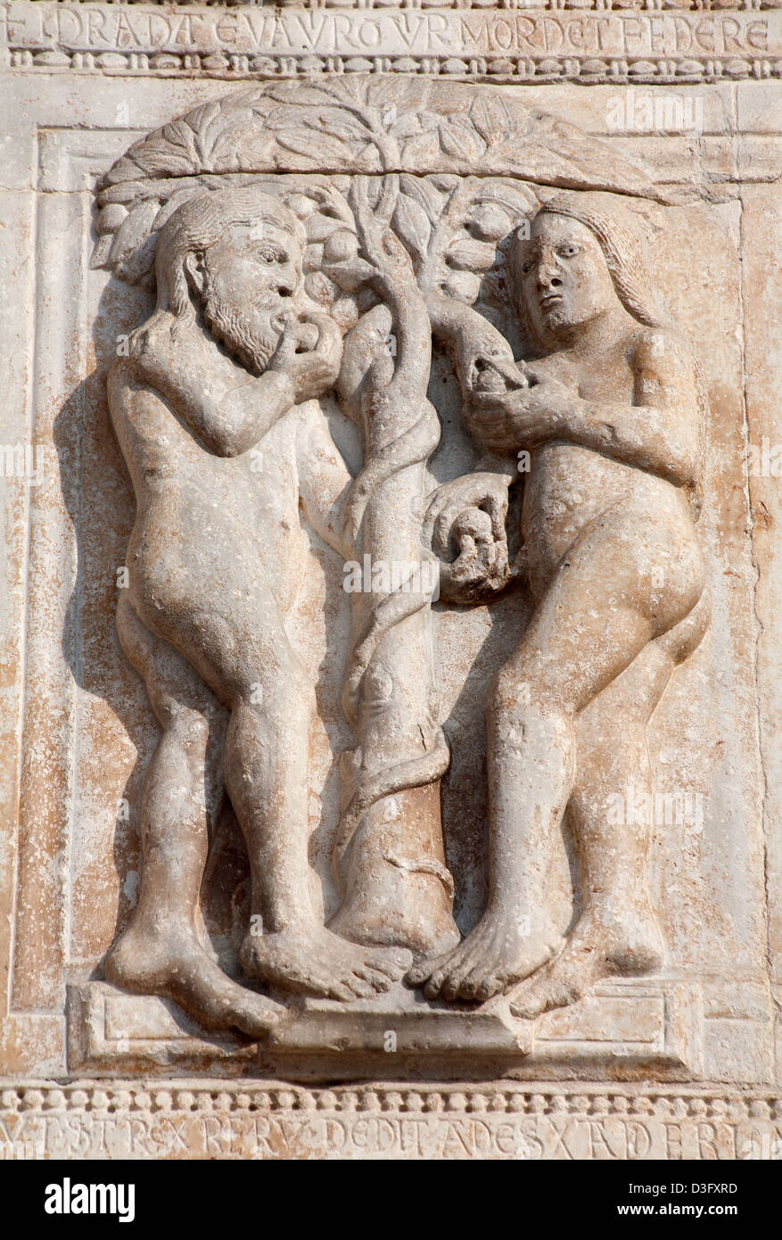 VERONA - JANUARY 27: Relief of Adam and Eva from facade of romanesque Basilica San Zeno Stock Photo