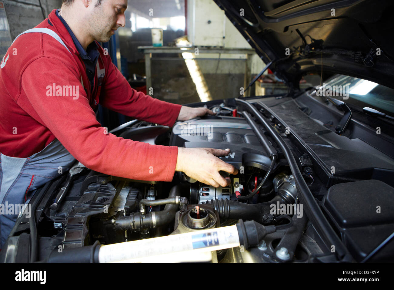 Car mechanic at work in his auto repair shop Stock Photo
