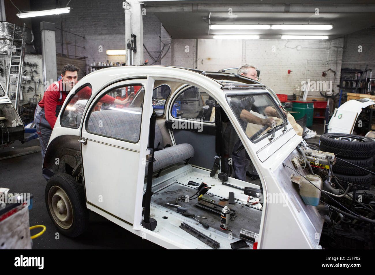 Car mechanics at work in their auto repair shop Stock Photo - Alamy