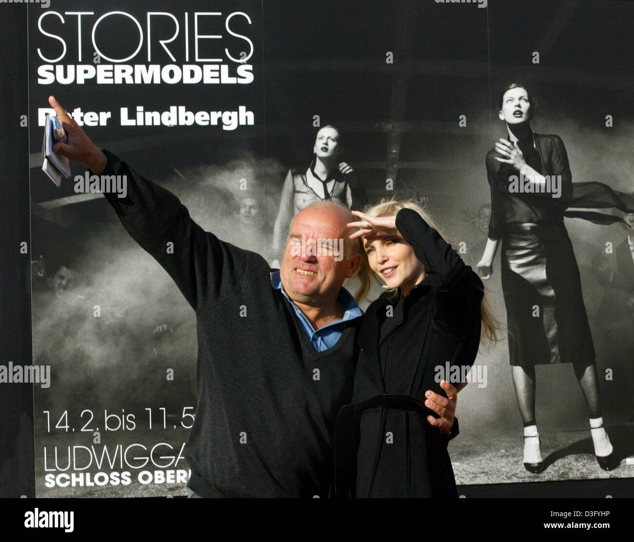 (dpa) - German star photographer Peter Lindbergh and model Nadja Auermann stand in front of a poster advertising Peter Lindbergh's exhibition 'Stories - Supermodels', in Oberhausen, Germany, 13 February 2003. The exhibition is open from 14 February until 11 May 2003. Centre of the exhibition is the series 'Invasion' which consists of 24 scurrile fashion photographs. Stock Photo