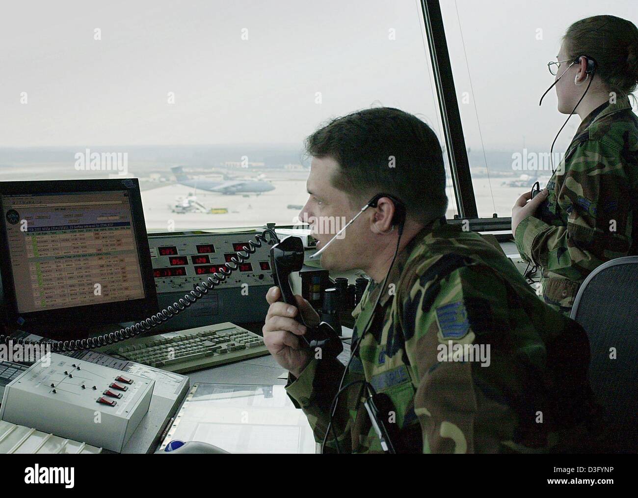 (dpa) - US soldiers control the airspace from the tower of the US airbase Ramstein near Landstuhl, western Germany, 10 February 2003. Ramstein is the biggest base of the US air force outside the United States. It is the home of the 86th airlift wing (transportation squadron) and the headquarter of the US Air Forces Europe. According to the newspaper 'Welt am Sonntag' the US defence Stock Photo