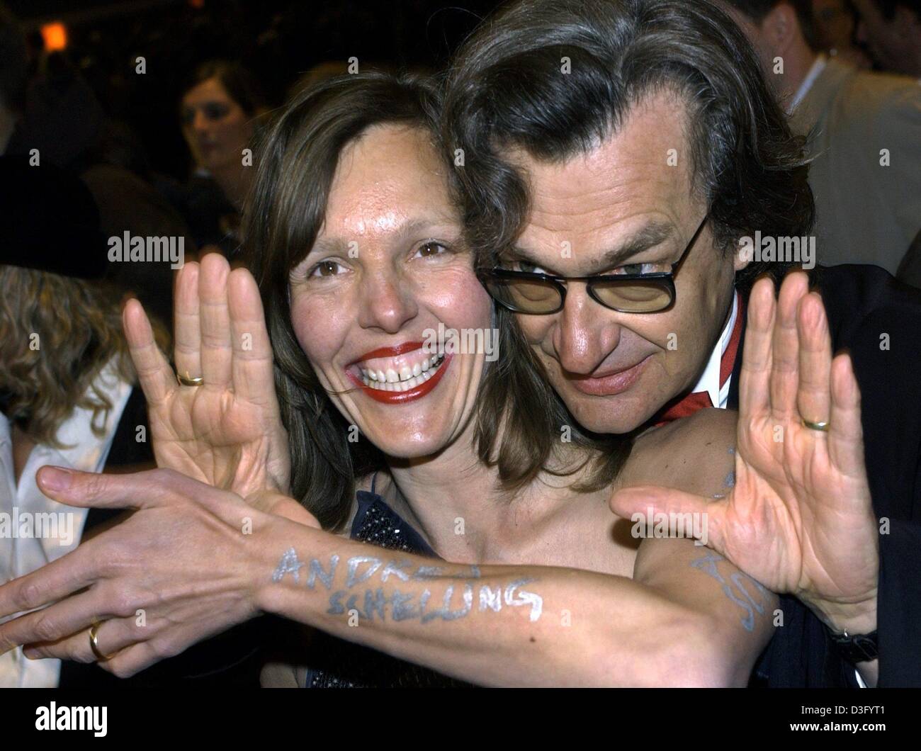 (dpa) - German film director Wim Wenders uses his hands as a viewfinder as he chats with his wife Donata Schmidt during the opening of the 53rd annual Berlin film festival in Berlin, 6 February 2003. Schmidt has 'Andrea Schelling' written on her arm, the name of her favorite fashion designer. More than 2,000 guests attended the opening ceremony of the Berlinale, which is after Cann Stock Photo