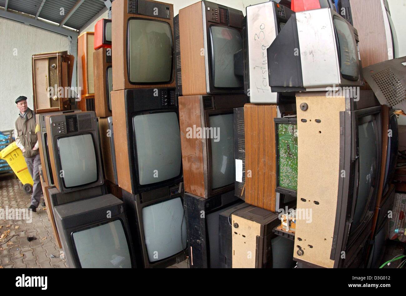 (dpa) - Old TV sets are stored at the recycling company ERV in Gera, Germany, 30 January 2003. The tellies and other electric devices are disassembled and some parts recycled. Last year the company handled 580 tons of electric scrap from households in Gera and the region. So far, electric scrap was collected free of cost twice a year. In Eastern Thuringia this will be reduced to on Stock Photo