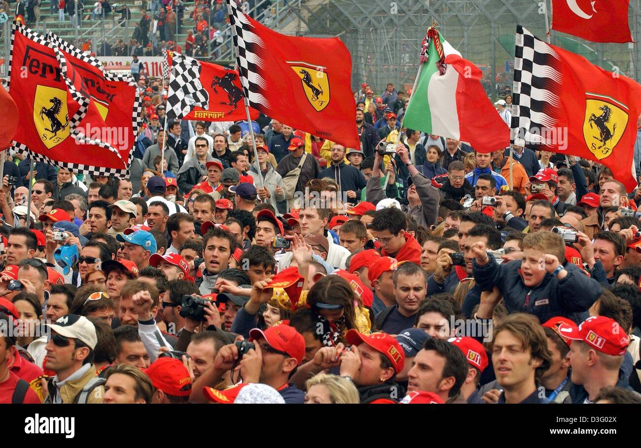 dpa) - Formula one fans wave Ferrari flags as they watch the Grand Prix of  San Marino at the racing track in Imola, Italy, 20 April 2003 Stock Photo -  Alamy
