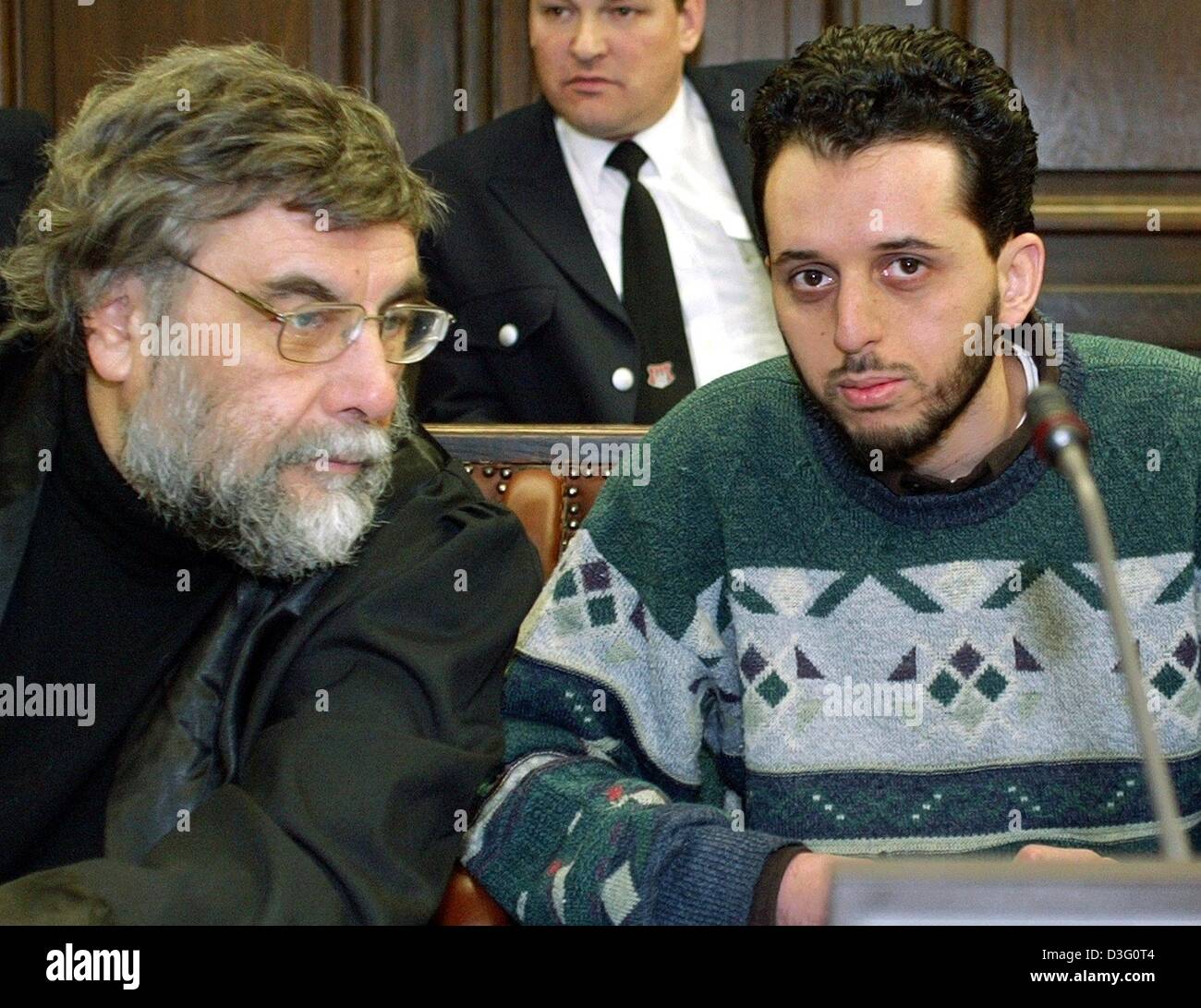 (dpa) - The accused Mounir al-Motassadeq (R) talks to his attorney Hartmut Jacobi in the court room of the regional court in Hamburg, 12 February 2003. The lawyer for Mounir al-Motassadeq, a friend of the 11 September terrorists, slammed the state's evidence 12 February against the Moroccan student as nothing but 'suppositions, allegations and interpretations'. The attorney said th Stock Photo