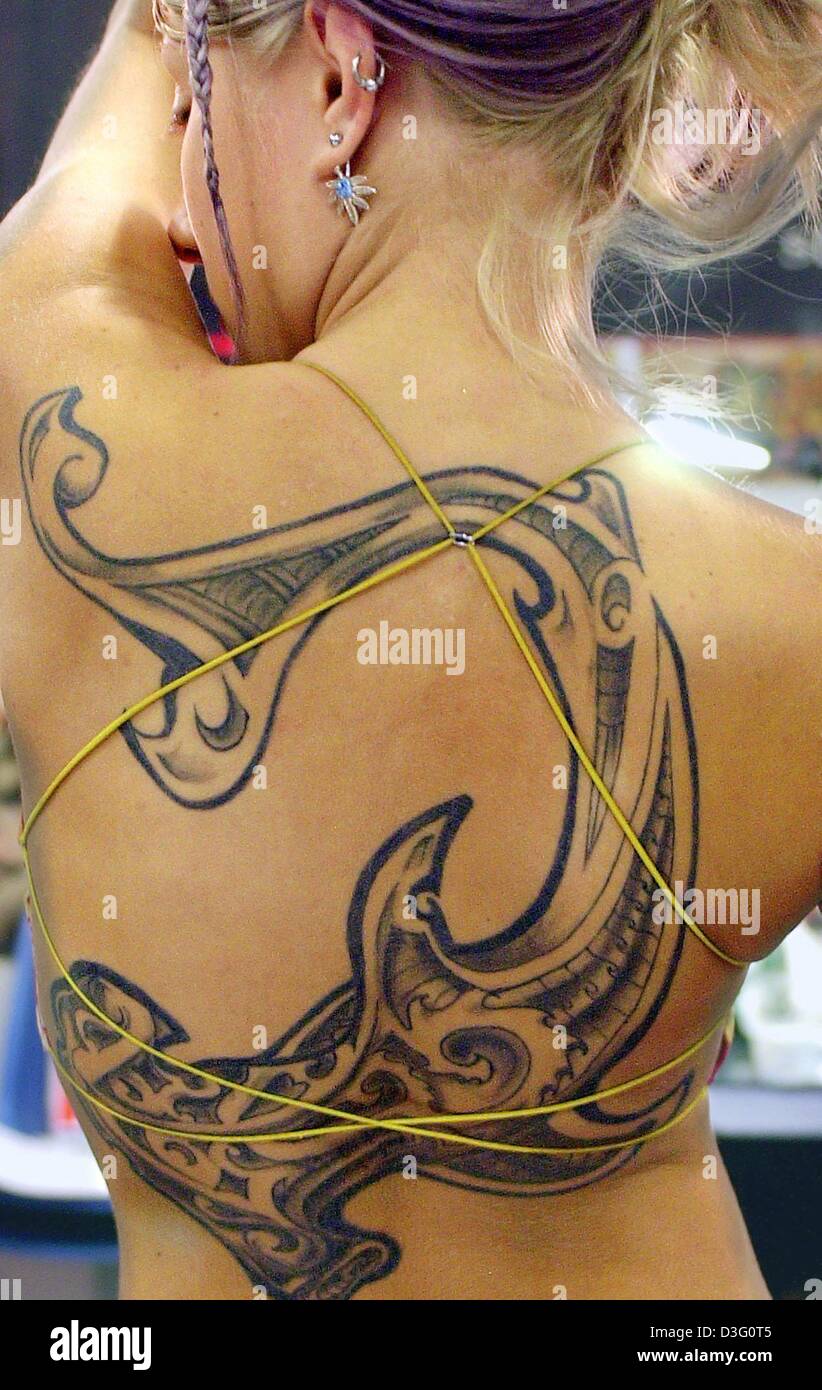 (dpa) - Jana presents a large tatto decorating her back at the 11th Tattoo-Convention in Frankfurt Main, Germany, 4 April 2003. Stock Photo