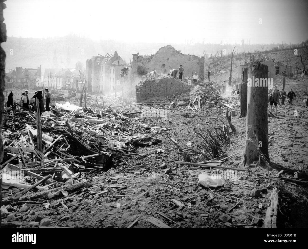 (dpa files) - Inhabitants search for usable household items in the destroyed houses in Pruem, western Germany, 15 August 1949. On 15 August 1949 more than 500 tons of ammunition, remnants of the German army in World War II, exploded in a subterranean bunker near Pruem. Large parts of the town of Pruem were destroyed. 11 people died and around 150 people were seriously injured. Stock Photo