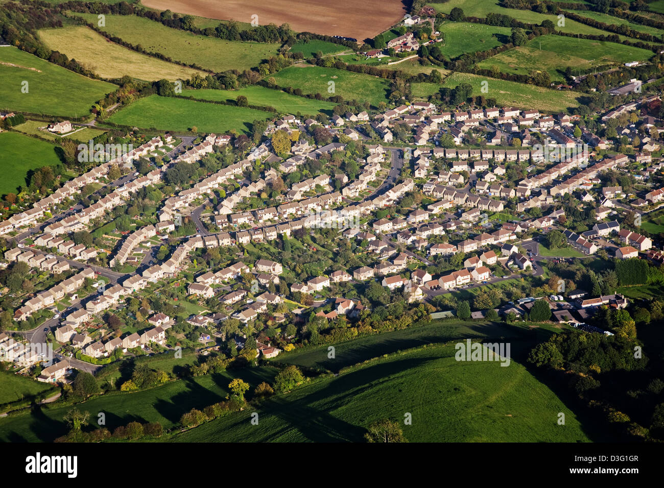 Aerial view of an English housing estate surrounded by green fields. Stock Photo