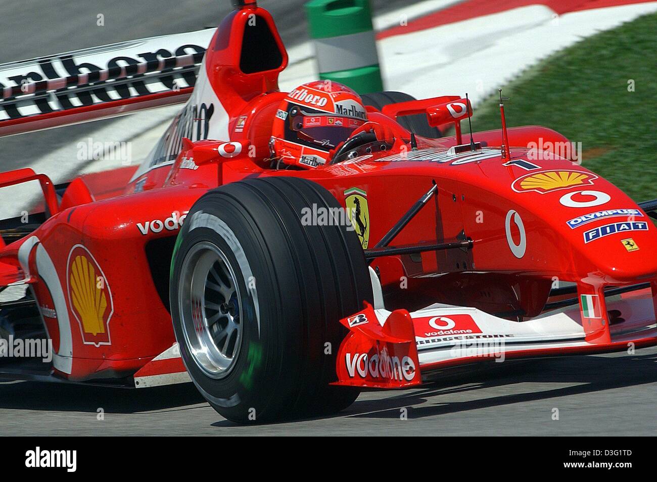 (dpa) - German formula one champion Michael Schumacher (Ferrari) drives with his boliden on the formula one race track in Kuala Lumpur, Malaysia, 21 March 2003. Schumacher drives the 5,543 kilometer race track in 1:34.980 minutes and achives best time during the free training round. The formula one grand prix race in Malaysia is the second race of the season and starts on 23 March  Stock Photo