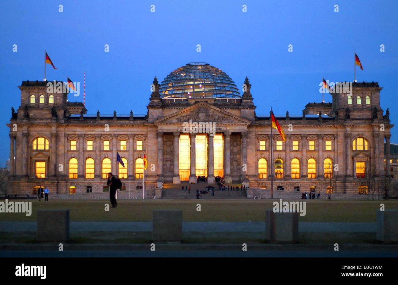 (dpa) - The red evening sun is reflected in the windows of the Reichstag building in Berlin, 18 March 2003. Built in 1894 by Paul Wallot, the Reichstag has been accommodating the Bundestag (Lower House of German Parliament) since 19 April 1999. The Italian High Renaissance style building has a changeful history: On 9 November 1918, the German Republic was proclaimed here. Shortly a Stock Photo