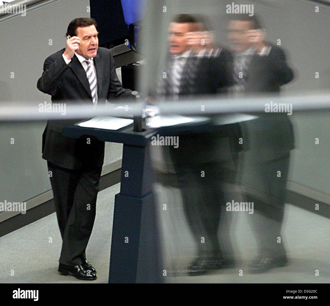 (dpa) - German Chancellor Gerhard Schroeder is gesturing during his eagerly awaited parliamentary speech in the Bundestag, the lower house of German parliament, in Berlin, 14 March 2003. In his speech, the Schroeder had called for a 'massive joint effort' to revive the country's huge but flagging economy. Every sector of society would have to make its contribution, he told parliame Stock Photo