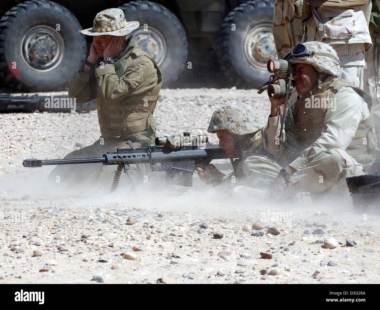 (dpa) - US marines of the Delta Company of the 3rd Light Amoured Reconnaissance Battalion (3rd LAR) practise shooting with live ammunition in Camp Coyote, Kuwait, 14 March 2003. More than 150,000 US and British soldiers are presently based in Kuwait's northern desert. According to the US Department of Defense, these soldiers are prepared to launch an attack on Iraq. Stock Photo