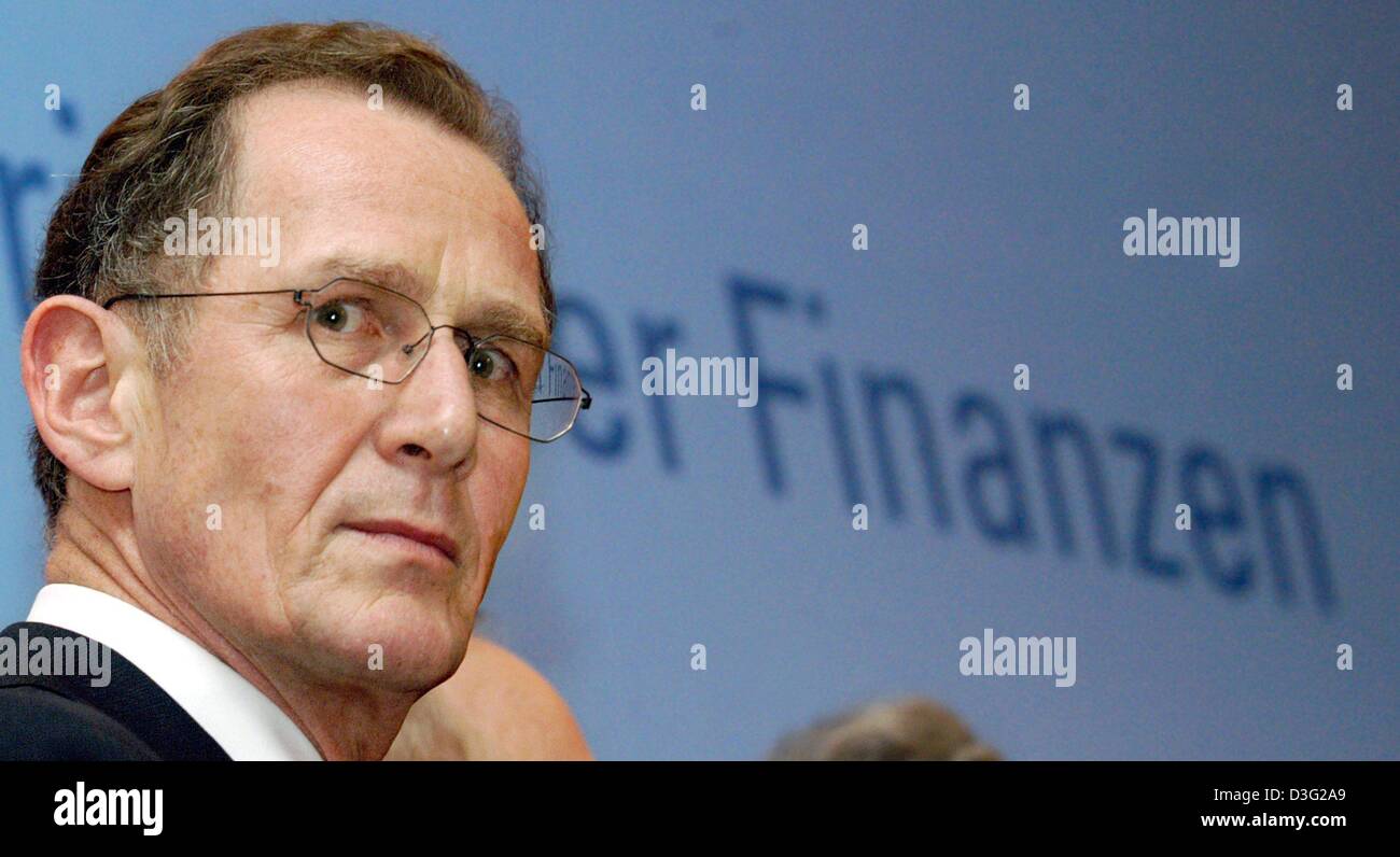 (dpa) - German pensions expert Bert Ruerup stands in front of the word 'Finanzen' (finances) in Berlin, 17 March 2003. The so-called Ruerup Commission handed over their study on future pension taxations to the German finance minister. Contributions for the pensions fund will, according to the concept, be free from taxes, whereas pensions paid to pensioners shall be taxed. According Stock Photo