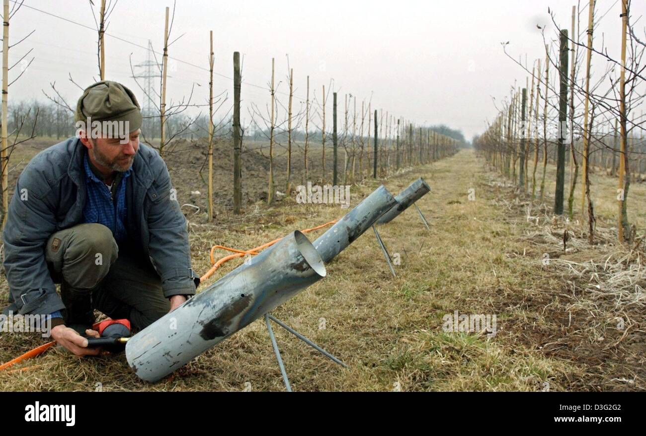 (dpa) - Farmer Peter zum Felde lights the gas heating for the ground of his farmland which is to protect his apple trees from frost in Guderhandviertel, Germany, 18 February 2003. During the northern German farmers' trade fair, Peter zum Felde presented a prototype to agriculturists and thereby caused a sensation. In the USA and Morocco, gas heating systems have been used for many  Stock Photo