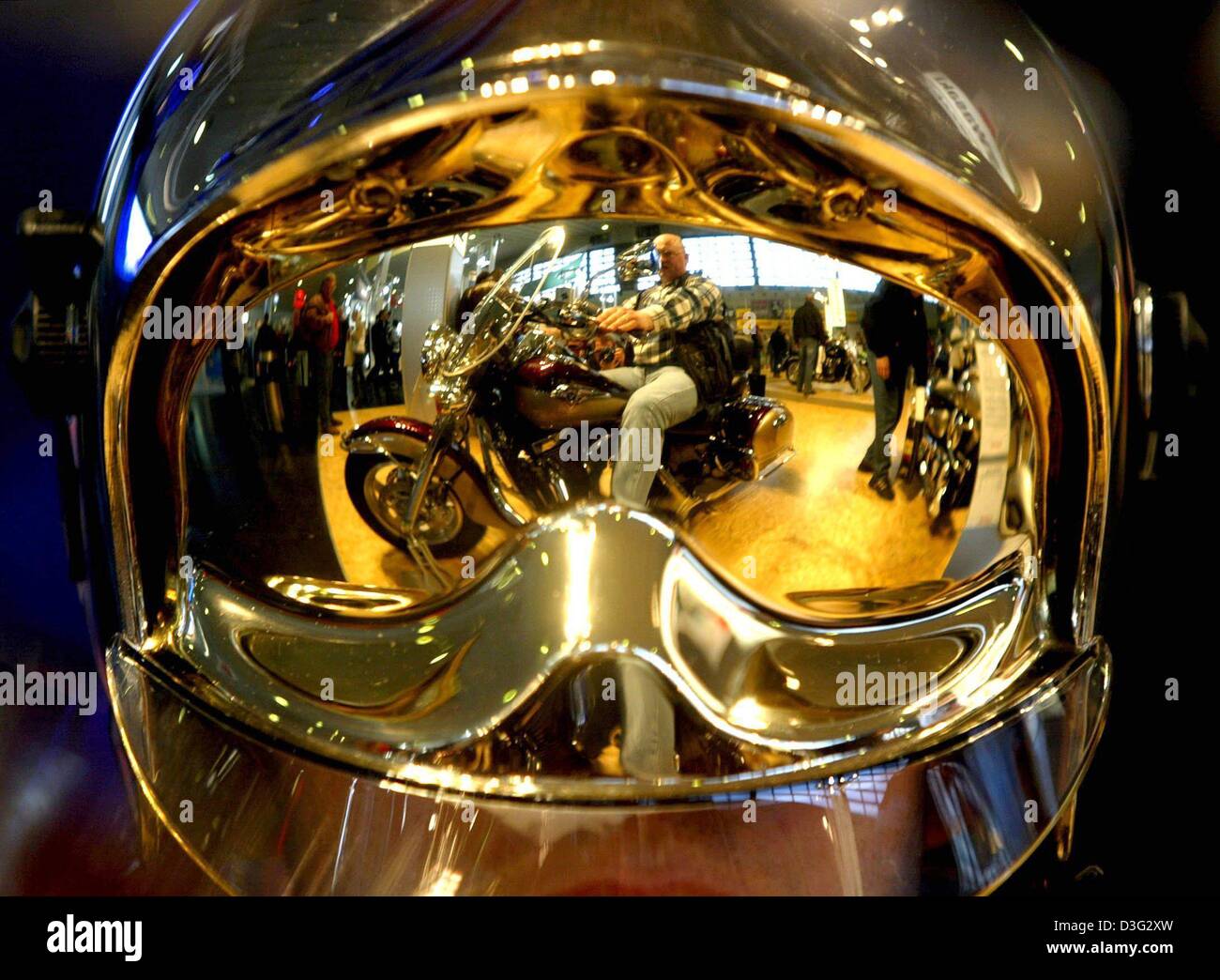 (dpa) - A motorbiker is mirrored on the visor of a helmet of a fireman at the 19th international motorbike trade fair in Dortmund, Germany, 5 March 2003. Stock Photo