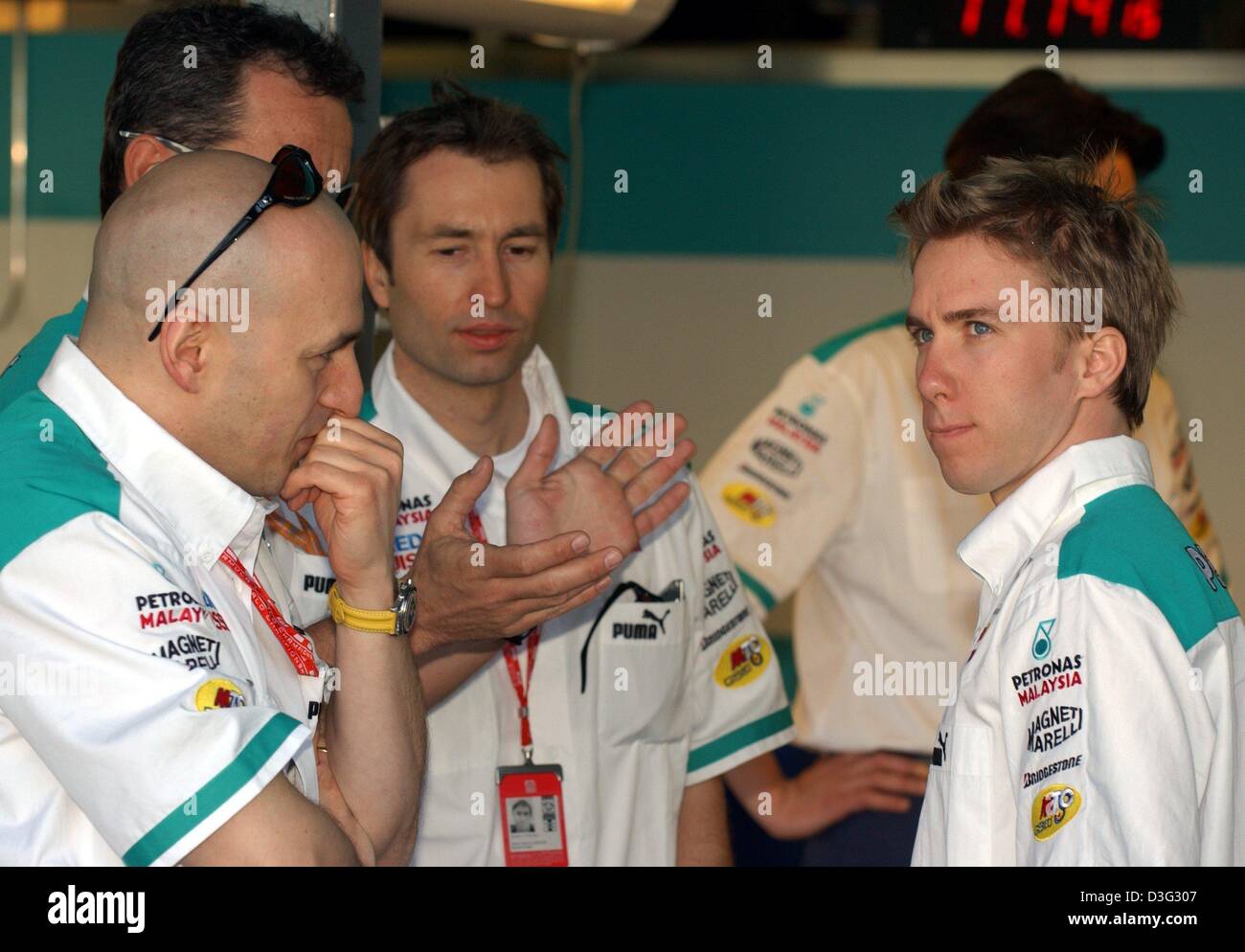 (dpa) - The German formula one pilots Nick Heidfeld (L) and Heinz-Harald Frentzen (C) pictured during a briefing of the Swiss Sauber team on the Albert Park race track in Melbourne, 6 March 2003. The Australian Grand Prix will kick off the formula one season on 9 March 2003 in Melbourne. Stock Photo