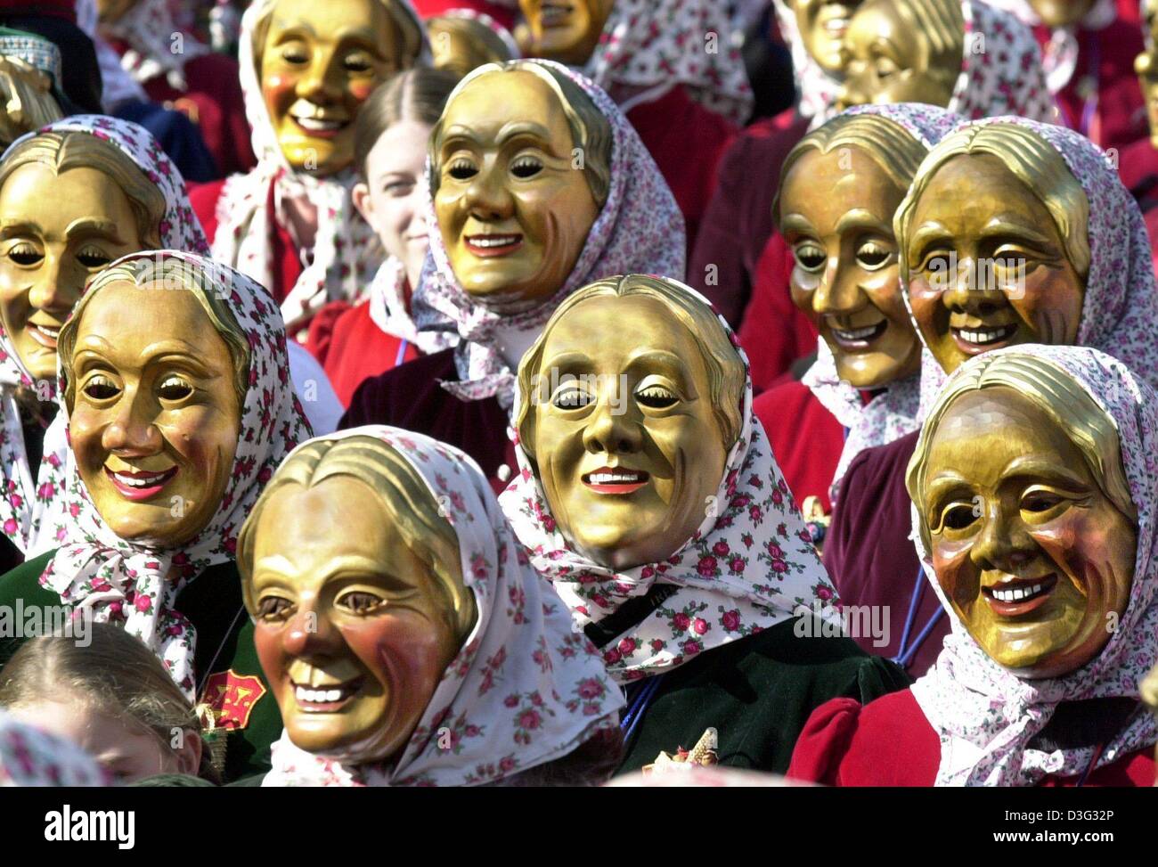 (dpa) - Identically clad women with masks, so-called 'Schnurrewiber', march through the streets to storm the town hall and to take over the power in Staufen, southern Germany, 27 February 2003. As a tradition, the carnival fools symbolically take over the power on the 'Schmotzige Dunschdig' (dirty thursday) to herald the climax of the carnival festivities of the Swabian-Alemannic c Stock Photo