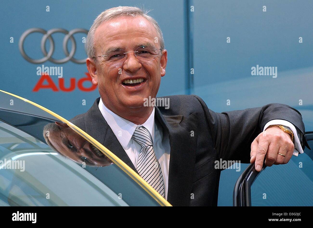 (dpa) - Martin Winterkorn, CEO of car manufacturer Audi, smiles in front of the company logo ahead of the annual results press conference in Ingolstadt, Germany, 25 February 2003. Audi is a subsidiary company of Volkswagen (VW). Audi announced that in 2002 turnover amounted to 22.6 billion Euro, which is a 2.6 per cent increase compared to the year before. After tax profits thus in Stock Photo