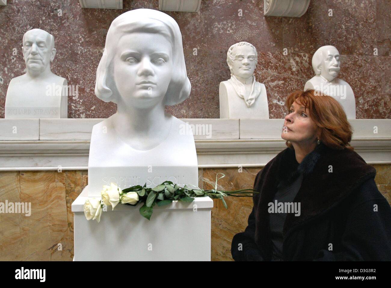 (dpa) - Actress Senta Berger stands next to the newly-unveiled bust of Nazi resistance fighter Sophie Scholl in the Walhalla in Donaustauf, southern Germany, 22 February 2003. A bunch of white roses lie in front of the bust. Sophie Scholl was a member of the 'Weisse Rose' (white rose) resistance group and was beheaded 60 years ago by the Nazis. The bust is the 127th marble bust in  Stock Photo