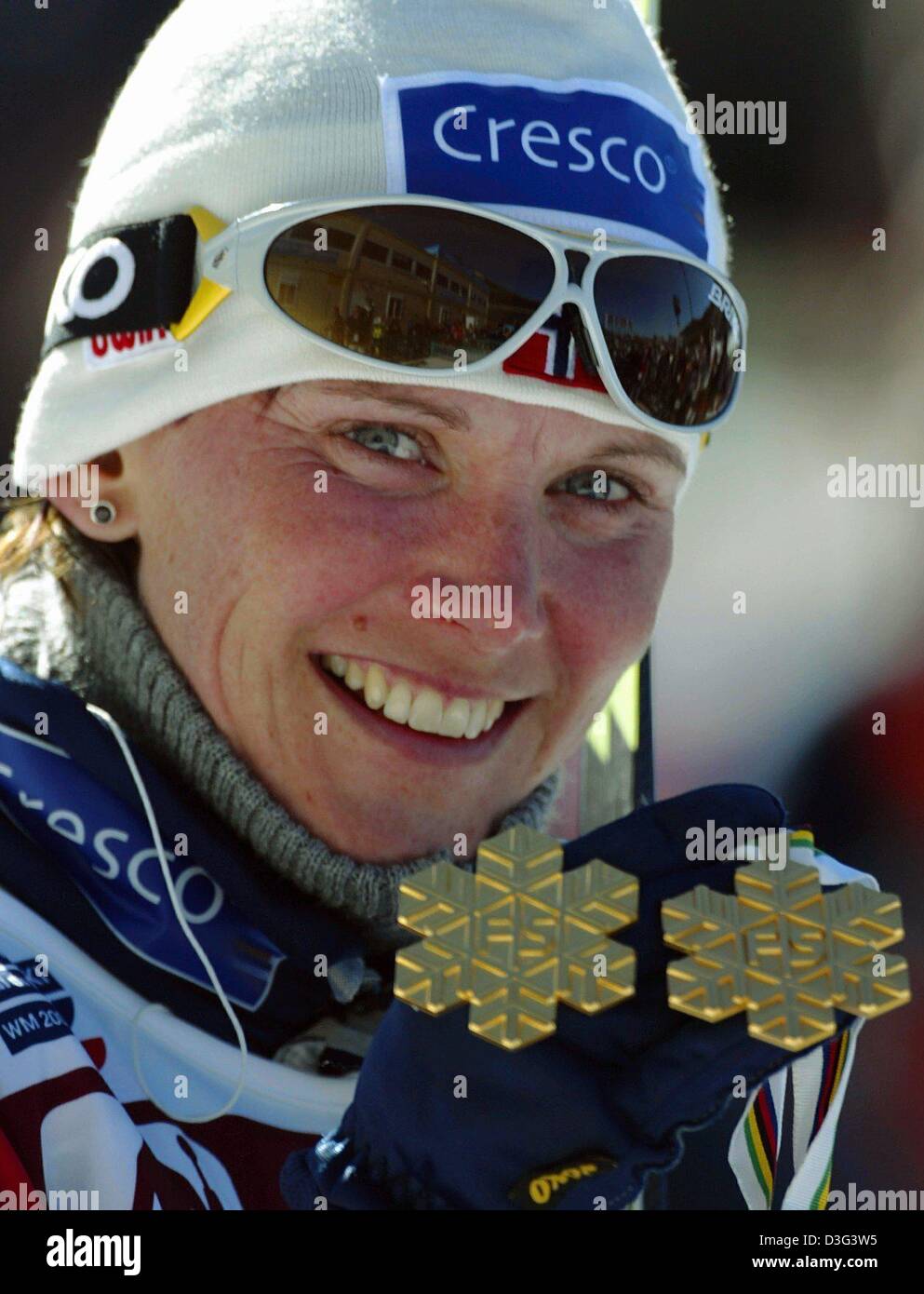 (dpa) - Norwegian Bente Skari shows her snow flake shaped gold medals after winning the 10 kilometres classic style race for women at the nordic skiing world championships in Tesero, Italy, 20 February 2003. Bente Skari has won her first gold medal in the 15 kilomentres classic style race. Stock Photo