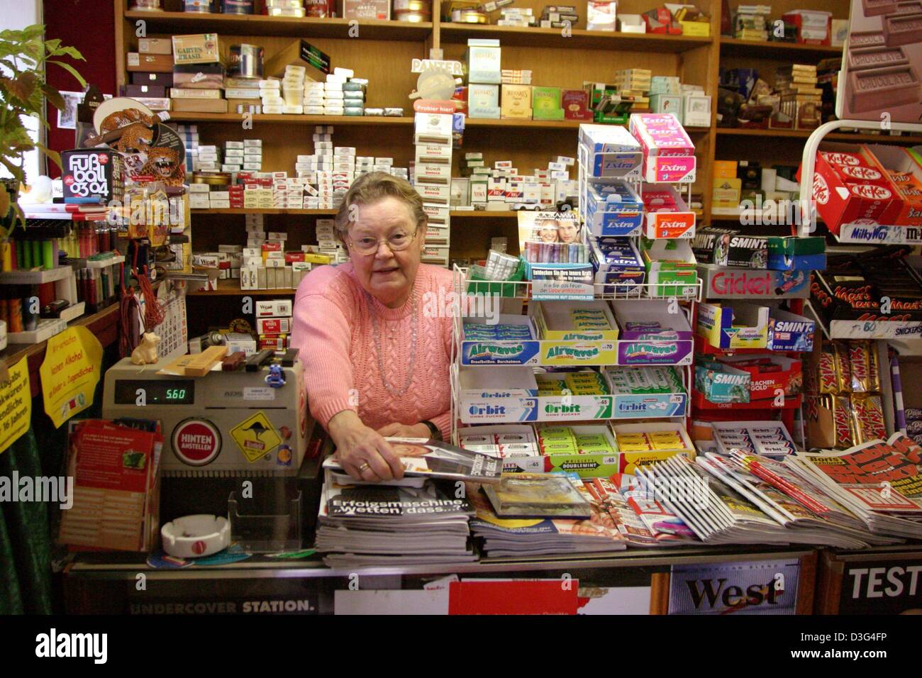 (dpa) - Amalie Keim, proprietor of a typical newspaper and tobacco kiosk in Germany, waits for customers behind the counter in Bielefeld, 4 November 2003. Stock Photo
