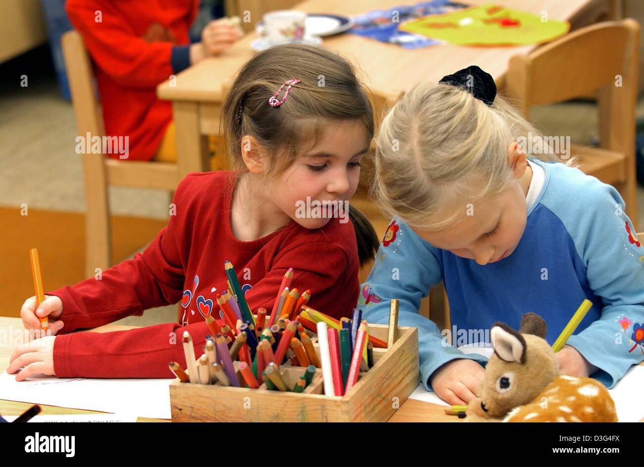 Dpa Two Girls Are Painting At The Daycare Kindergarten Centre