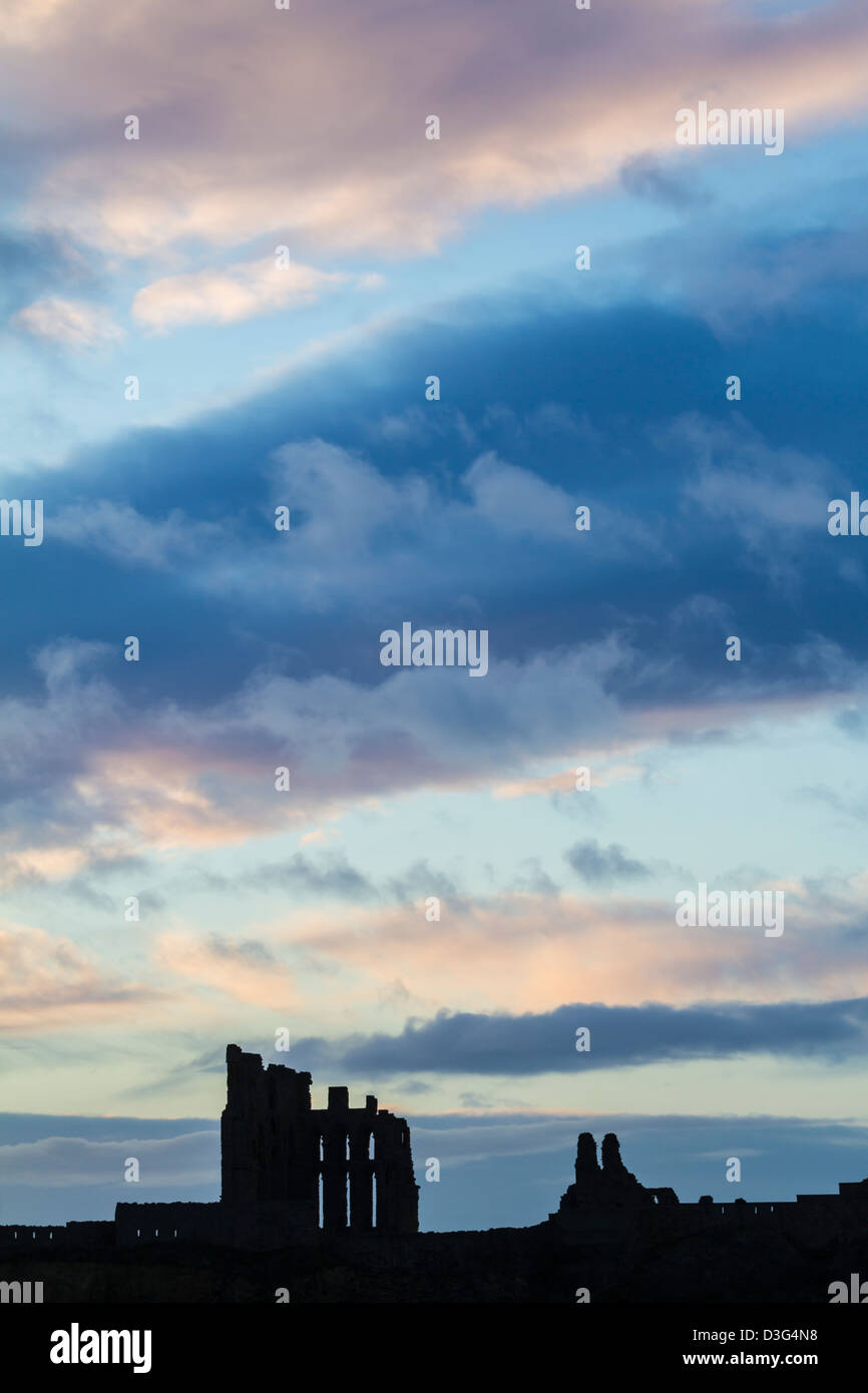 The ruins of Tynemouth priory silhouetted by a winter's sunrise, Tyne and Wear, England Stock Photo