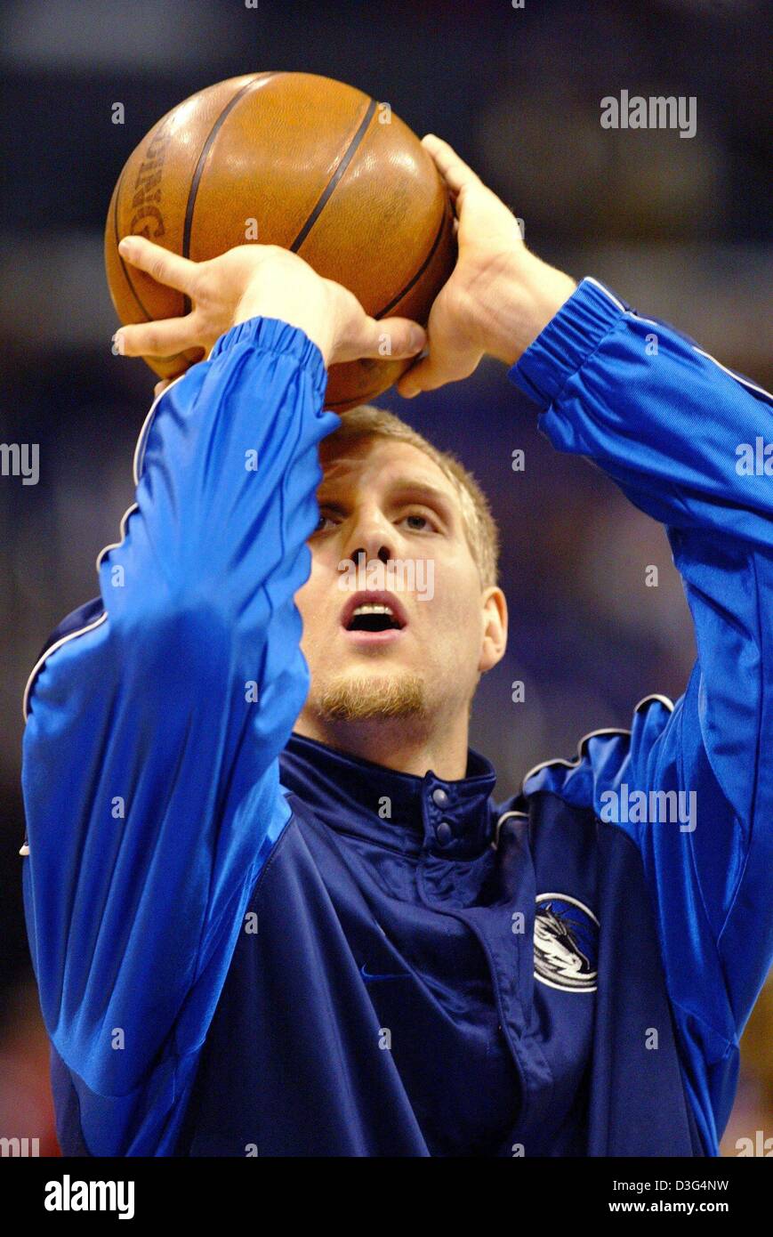 (dpa) - German basketball pro Dirk Nowitzki, who plays for the Dallas Mavericks, practices with a basketball before the start of the NBA championship match between Dallas Mavericks and Los Angeles Lakers in Los Angeles, California, USA, 13 December 2003. Dallas won the game by a score of 110-93. It was the first victory in 13 years against the Lakers who had previously won against  Stock Photo