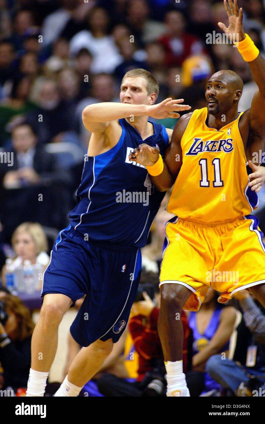 (dpa) -  German basketball pro Dirk Nowitzki (R), who plays for the Dallas Mavericks, struggles for the ball with Karl Malone, who plays for the Los Angeles Lakers,  during the NBA championship match between Dallas Mavericks and Los Angeles Lakers in Los Angeles, California, USA, 13 December 2003. Dallas won the game by a score of 110-93. It was the first victory in 13 years agains Stock Photo