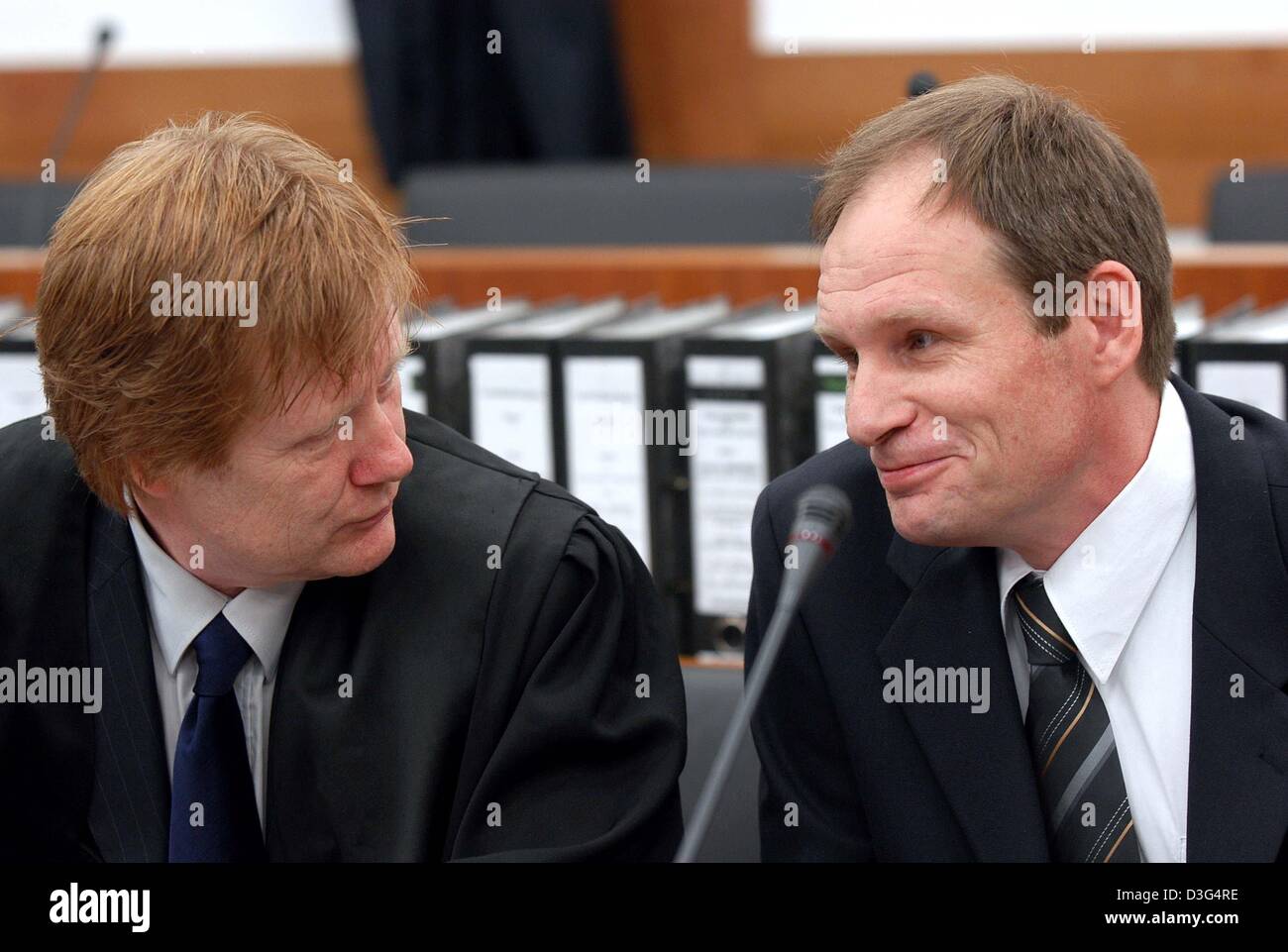 (dpa) - 42-year-old German computer specialist Armin Meiwes (R) chats with his lawyer Harald Ermel during his trial at the district court in Kassel, Germany, 12 December 2003. The German murder trial of the self-declared cannibal will hear evidence on 12 December of the effects of alcohol and medication on his victim. A toxicologist will give testimony on the third day of the trial Stock Photo