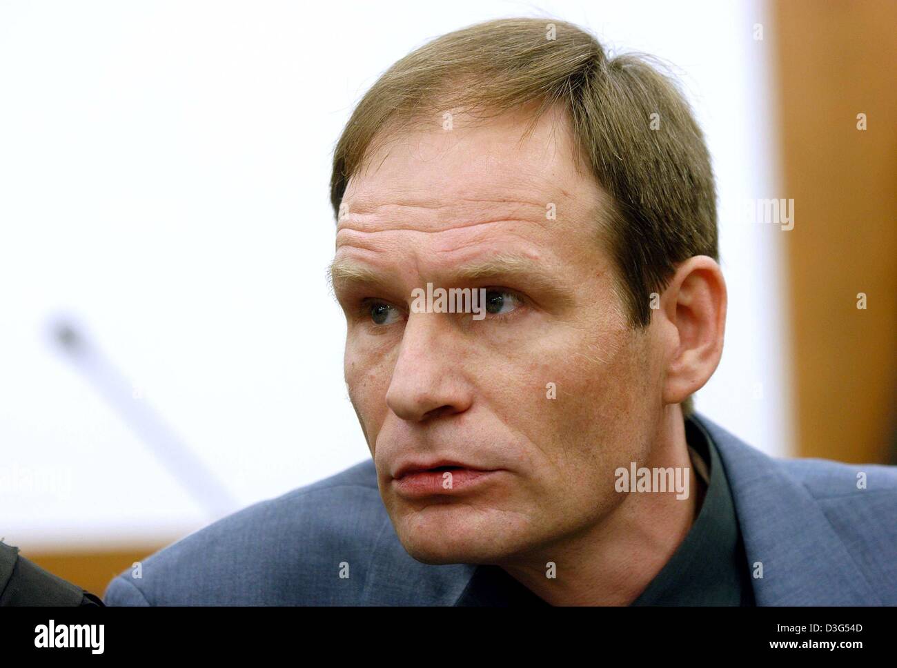 (dpa) - 42-year-old German computer specialist Armin Meiwes pictured during the second day of his trial at the district court in Kassel, Germany, 8 December 2003. The court was set to view video tapes showing how the self-declared cannibal killed, cut up and ate his victim. The second day of the murder trial of Meiwes began with evidence to be given by police who visited the crime  Stock Photo