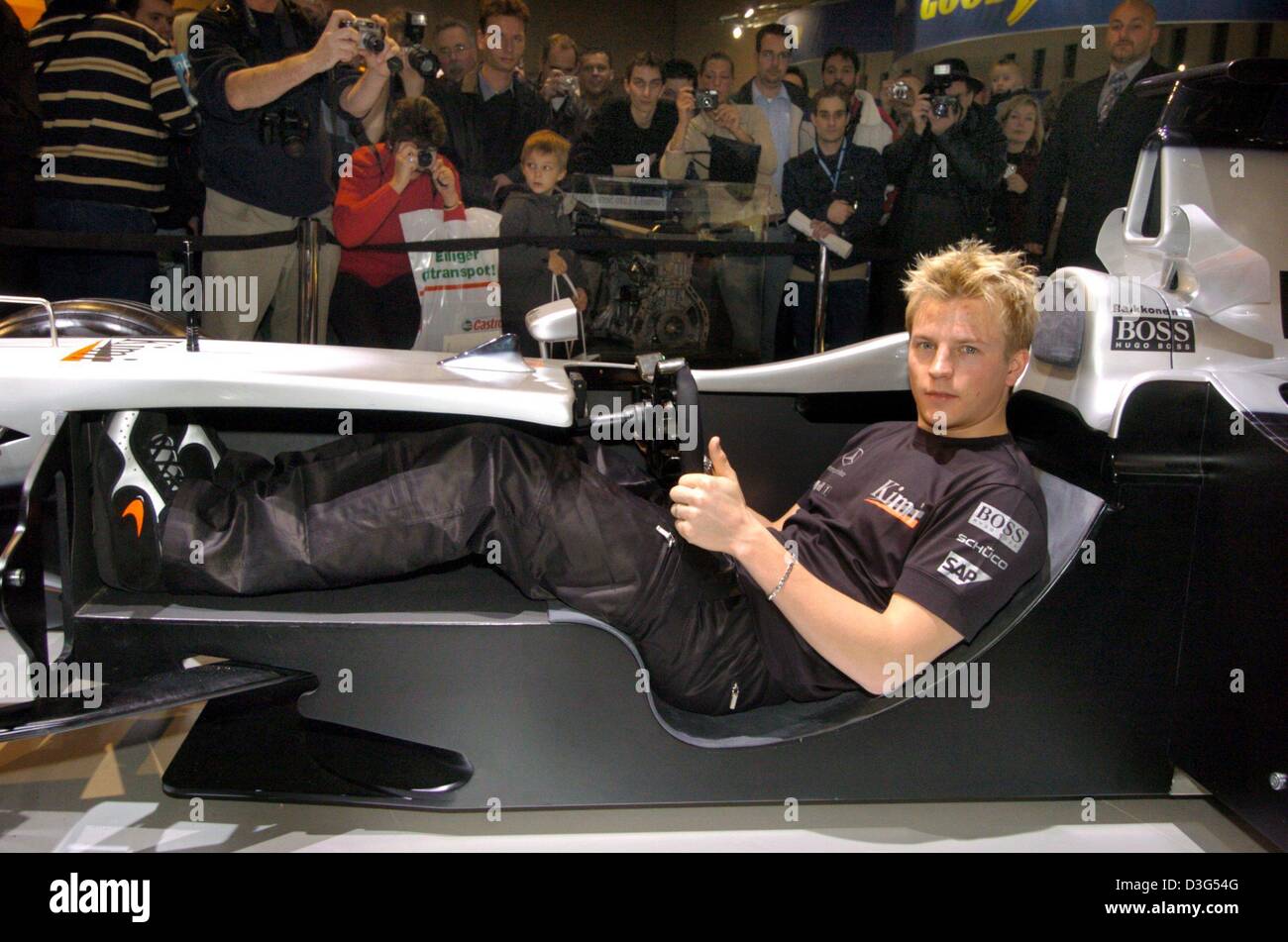 (dpa) - Finnish formula one pilot Kimi Raeikkoenen demonstrates in an open race car how formula one drivers sit in their bolides at the market stand of his McLaren-Mercedes racing team at the Motor Show in Essen, Germany, 6 December 2003. Stock Photo