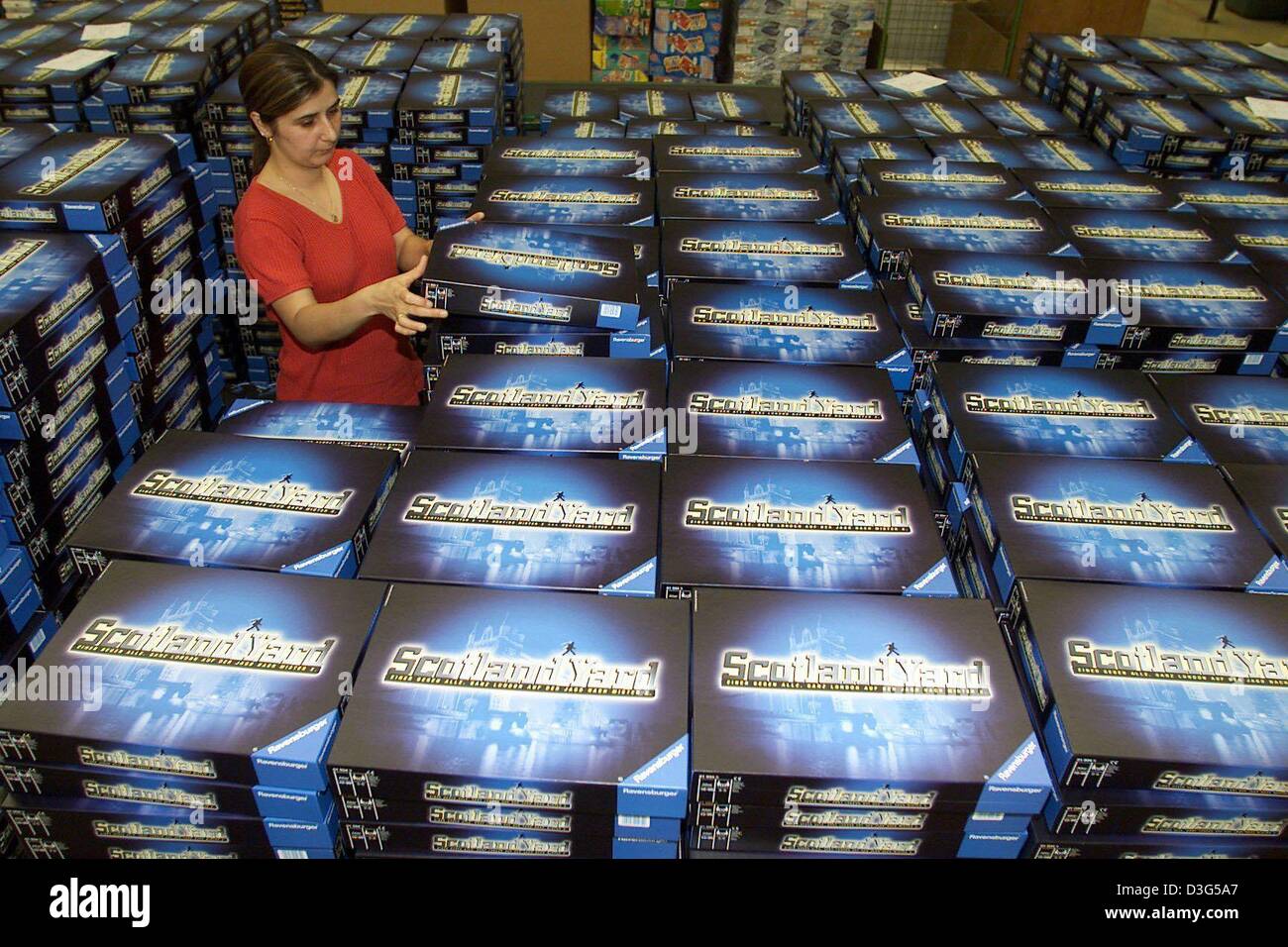 (dpa files) - An employee of the toy maker Ravensburger stacks boxes of the board game Scotland Yard in Ravensburg, Germany, 3 July 2001. Board games, electric model railways and puzzles are still among the favourite Christmas presents. Stock Photo