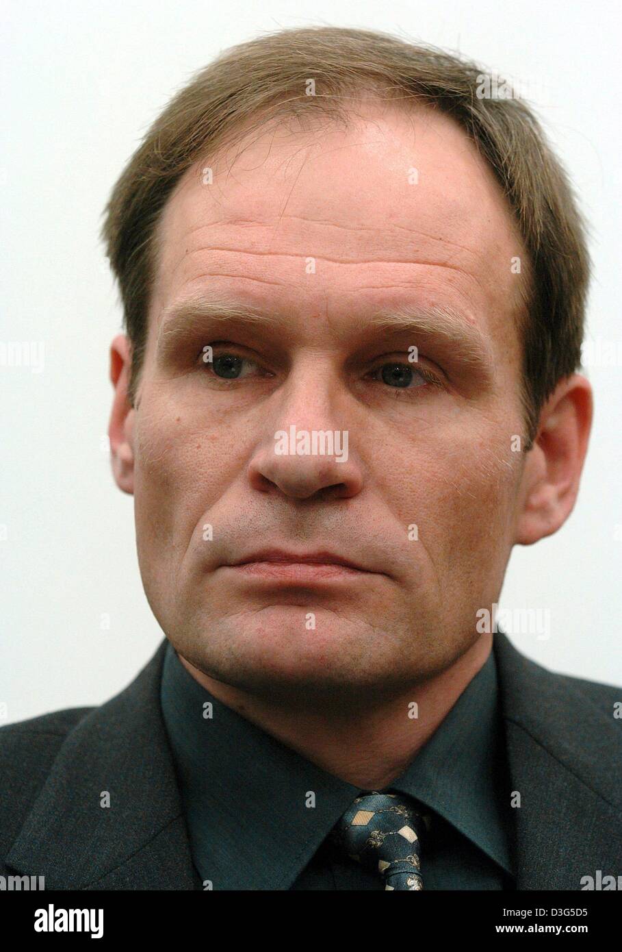 (dpa) - Armin Meiwes (R), accused of cannibalism, sits in the regional court in Kassel, Germany, 3 December 2003. The trial of the man who killed and then ate his victim before a running camera began in Kassel in what legal experts say is an unprecedented case for Germany. The defendant, 42-year-old Armin Meiwes, is answering a charge of murder, while his defence counsel will seek  Stock Photo