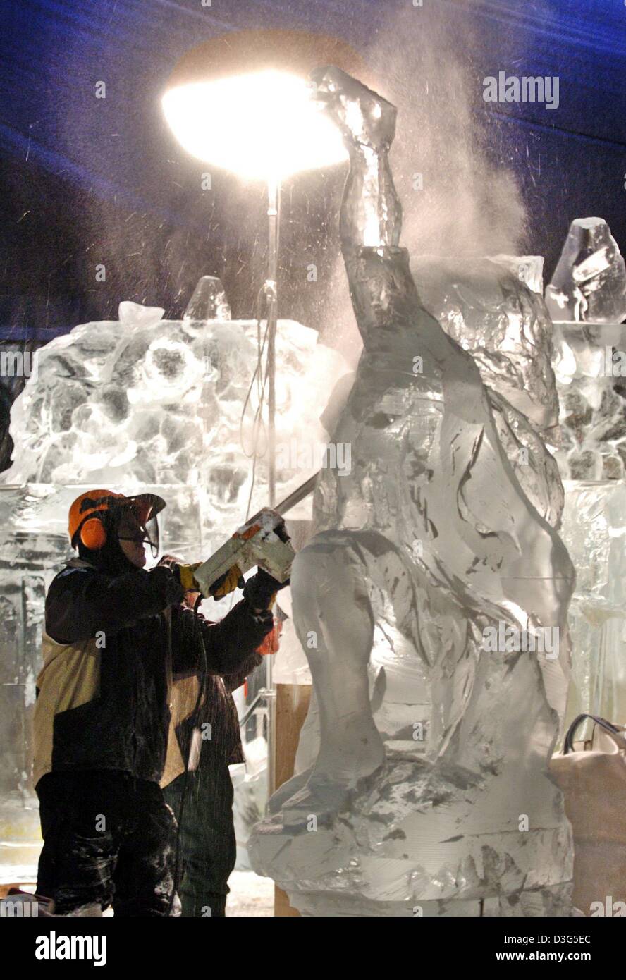 (dpa) - An artist with a chainsaw works on an ice sculpture for the Ice World exhibition in Luebeck, Germany, 27 November 2003. The exhibition takes place in a tent which is cooled down to minus 10 degree Celsius and runs from 12 December 2003 until 25 January 2004. Stock Photo