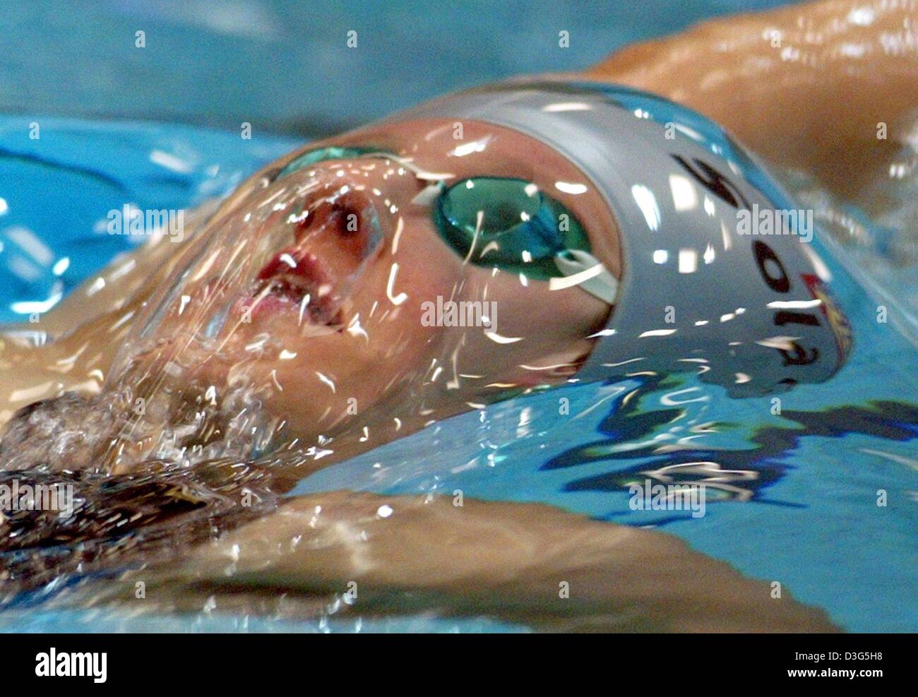 (dpa) - German swimmer Antje Buschschulte is in action during the 100 m backstroke at the German short course championships in Gelsenkirchen, Germany, 30 November 2003. She wins the event in 59.16 seconds. Stock Photo