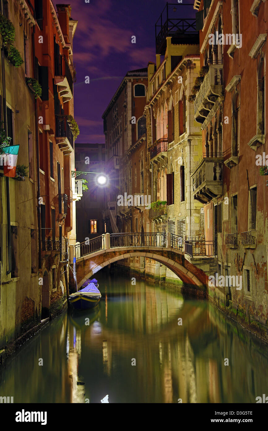 Night scene of a deserted bridge over a canal in Venice, Italy Stock Photo