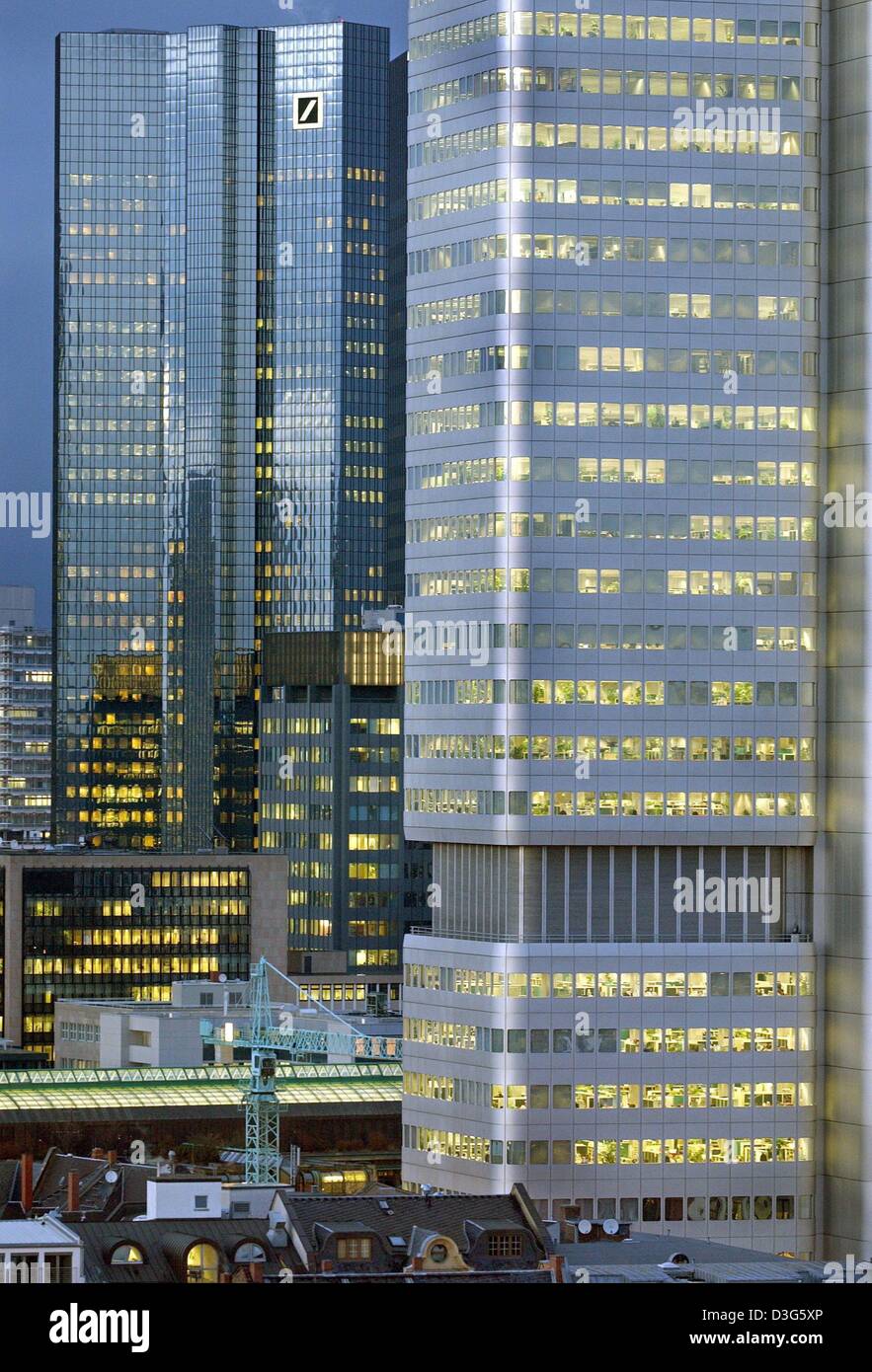 (dpa file) - The high-rises of the Deutschen Bank (L) and the Dresdner Bank are cast in blue light at sunset in Frankfurt Main, Germany, 22 January 2003. The three largest banks in Frankfurt, the Deutsche, Dresdner and Commerzbank, are now considering to form together a Germany super-bank. First exploratory talks have already taken place. Stock Photo