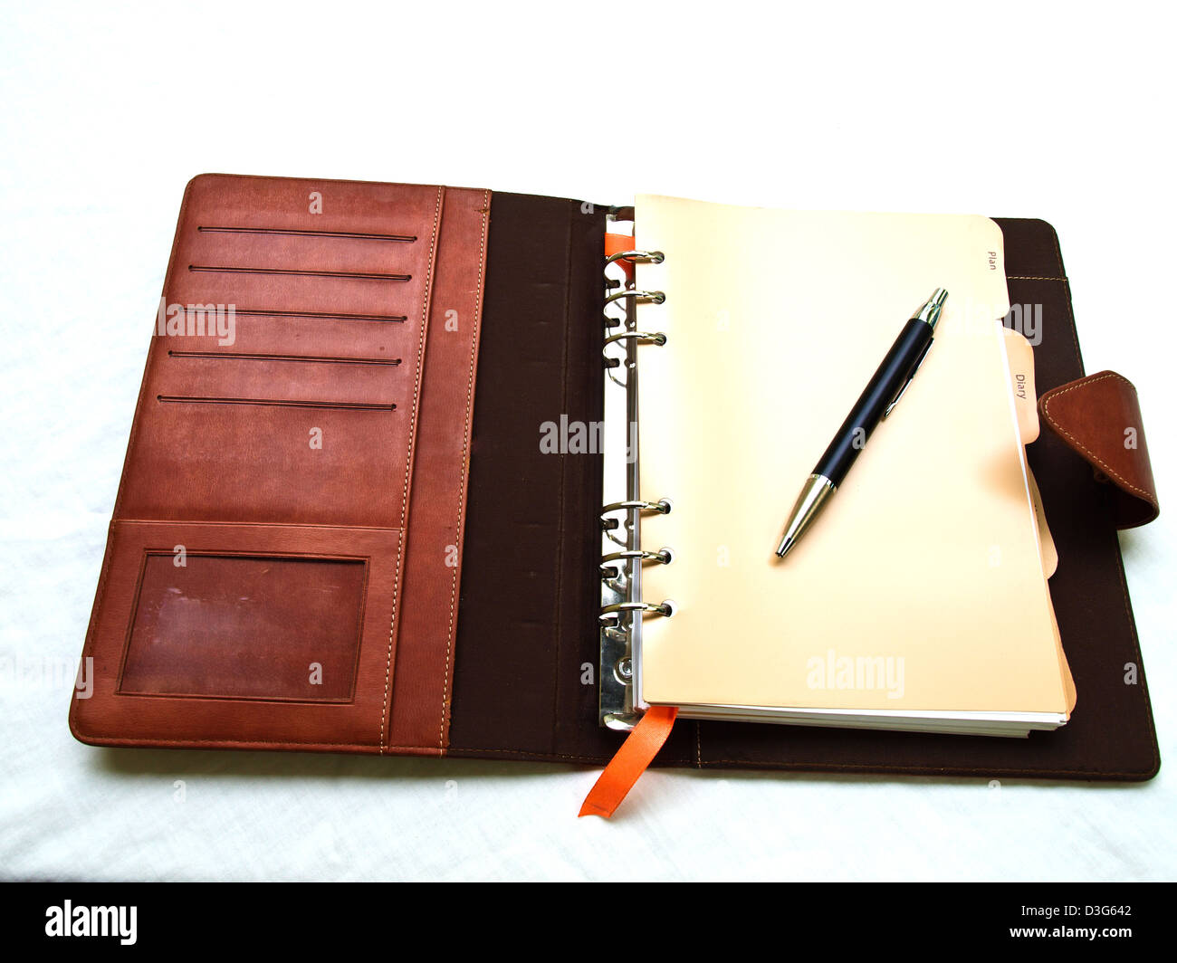 Opened redbrown organizer with a pen Stock Photo Alamy