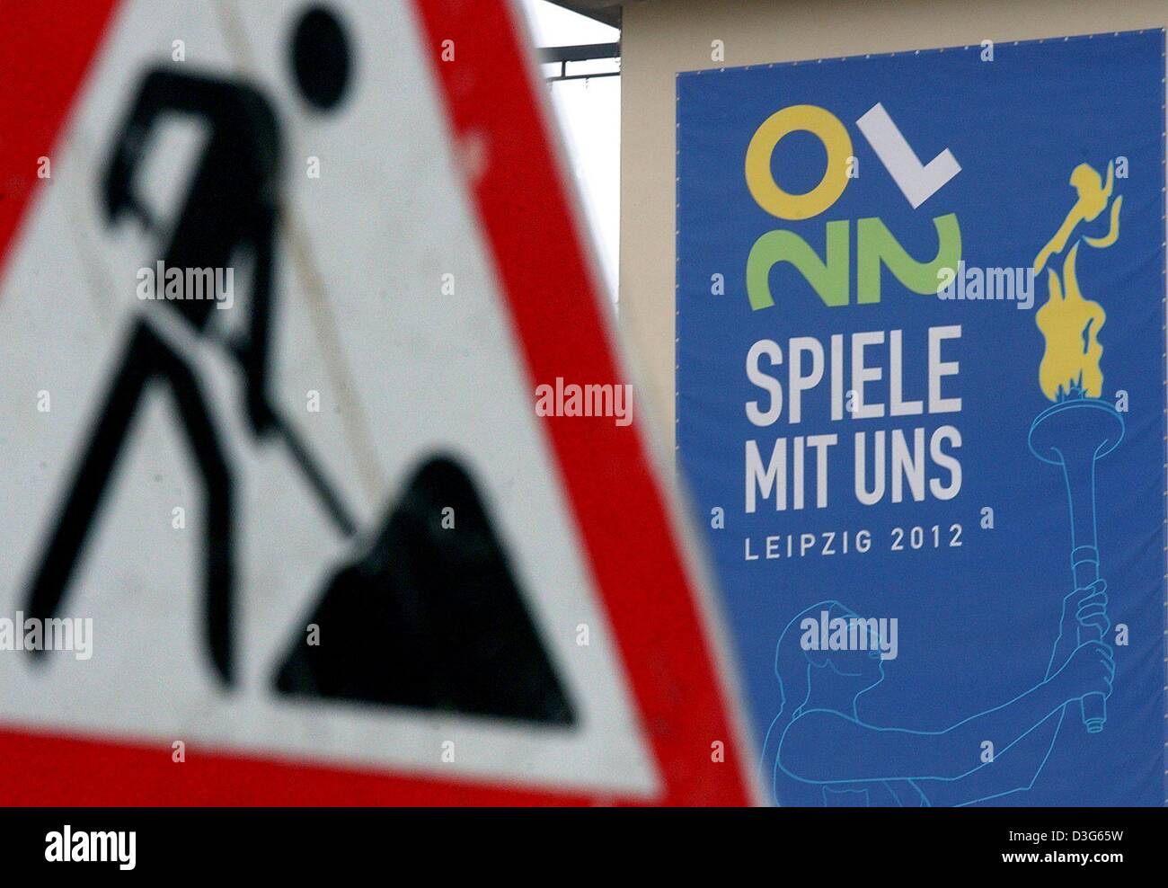 (dpa) - A road sign (L), indicating a construction site ahead, stands in front of a poster which displays the application logo for the 2012 Olympic Games in Leipzig, Germany, 18 November 2003. The arguments surrounding Leipzig's application to host the Olympic Games may effect other German sporting associations. The German fencing association is concerned at the moment because the  Stock Photo