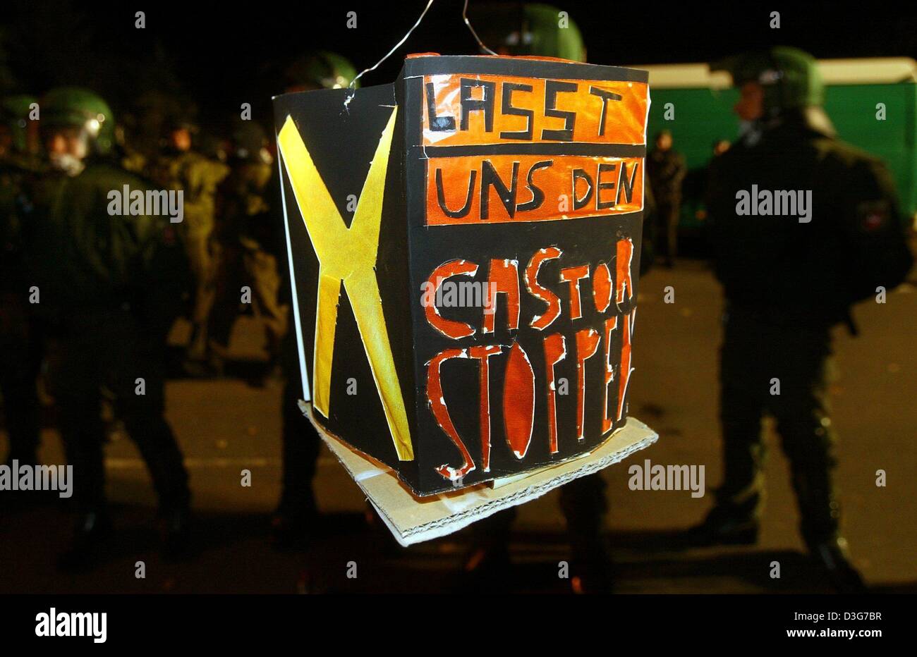 (dpa) - The writing on the illuminated self-made lantern reads 'Let's stop Castor' during a protest rally against the Castor transport of nuclear waste in Gross Gusborn, Germany 10 November 2003. Around 200 young protesters, supported by local farmers with their tractors, have blocked the railtracks along the route of the Castor transport. However, police managed to clear the track Stock Photo