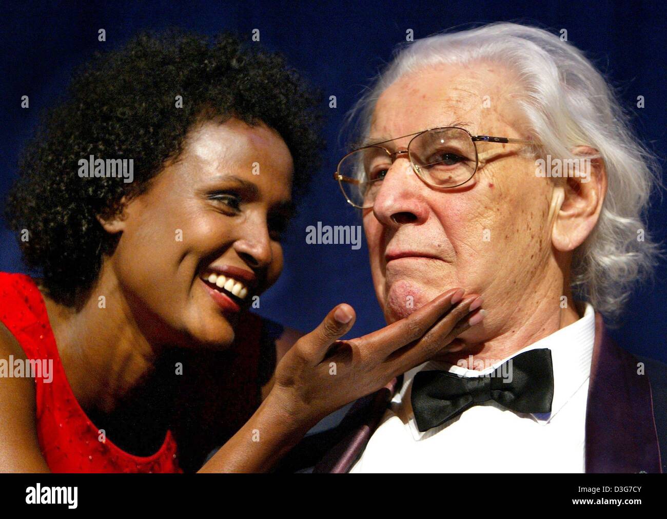 (dpa) - Top model and UNICEF ambassador Waris Dirie from Somalia tickles Sir Peter Ustinov, Unicef representative and patron of the evening, under the chin during the UNESCO Children's Fund benefit gala held at a hotel in Neuss, Germany, 8 November 2003. At the gala Waris Dirie was awarded the UNESCO Children's Fund's 'Children's Pyramids Award' for her fight for women's rights and Stock Photo