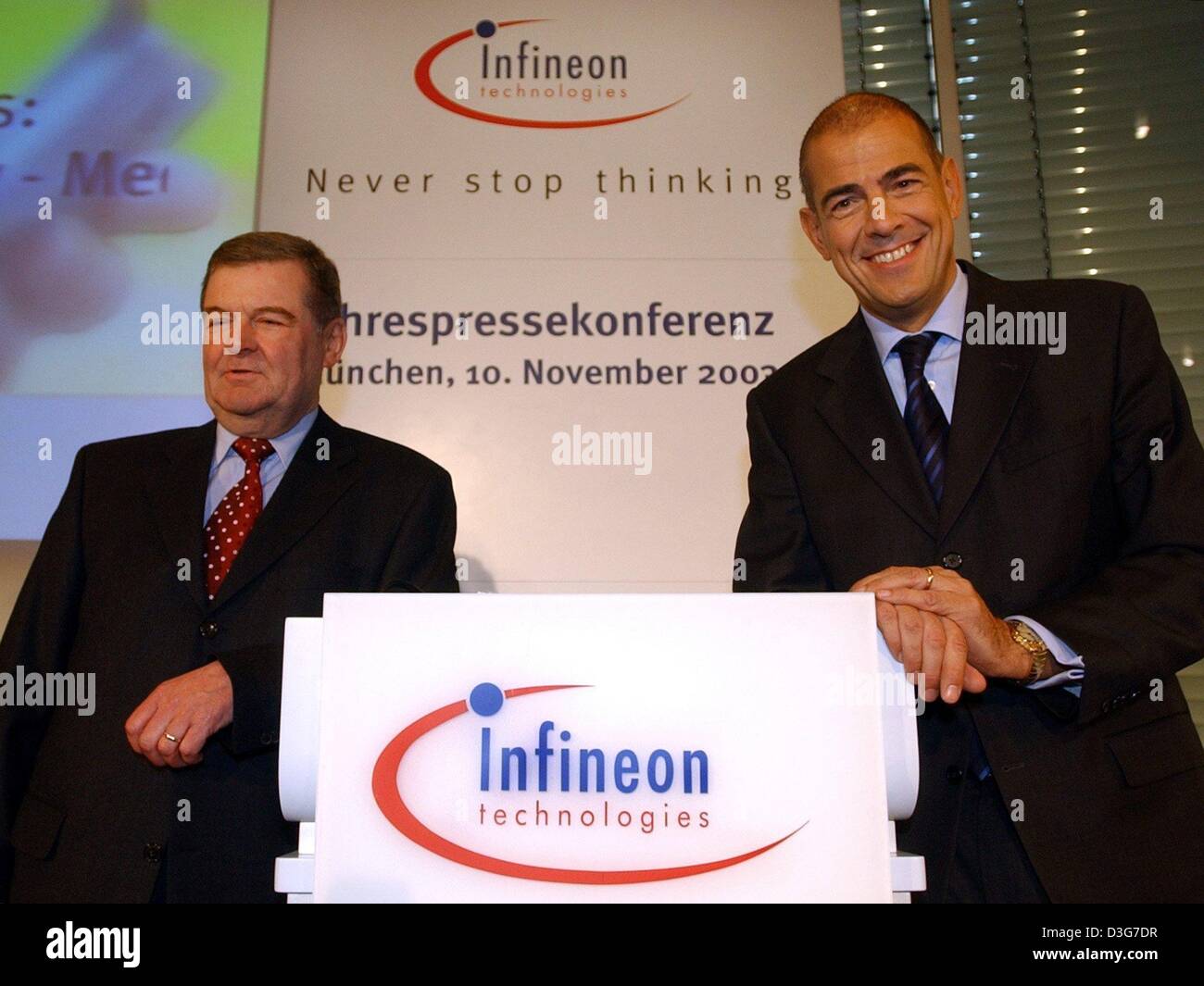 (dpa) - Ulrich Schumacher (R), Chairman of Germany's largest chip maker Infineon Technologies, and CFO Peter Fischl pose next to the company logo ahead of a results press conference in Munich, 10 November 2003. The company said it returned to the black in the final quarter of the 2002-2003 year for the first quarterly profit in over two years, and the company now expects to post bl Stock Photo