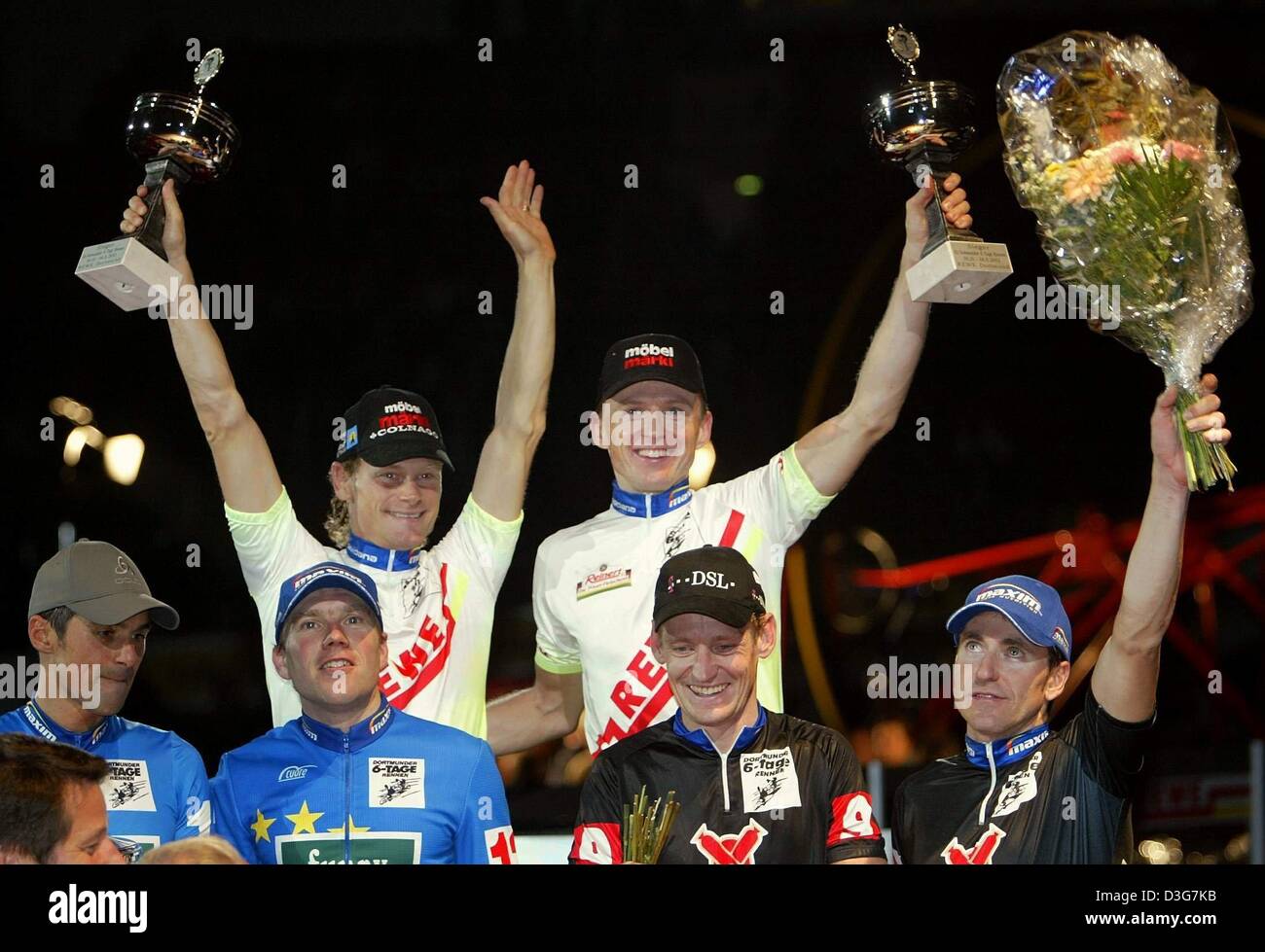 (dpa) - The Swiss team of Bruno Risi (top, L) and Kurt Betschart (top, R) are all smiles after winning the six days race in Dortmund, Germany, 5 November 2003. The title defenders, Germany's Andreas Kappes (L, below) and Andreas Beikirch (2nd from L, below) win second place, and the team of German Rolf Aldag (2nd from R, below) and Australian Scott McGrory (R, below) finish third. Stock Photo