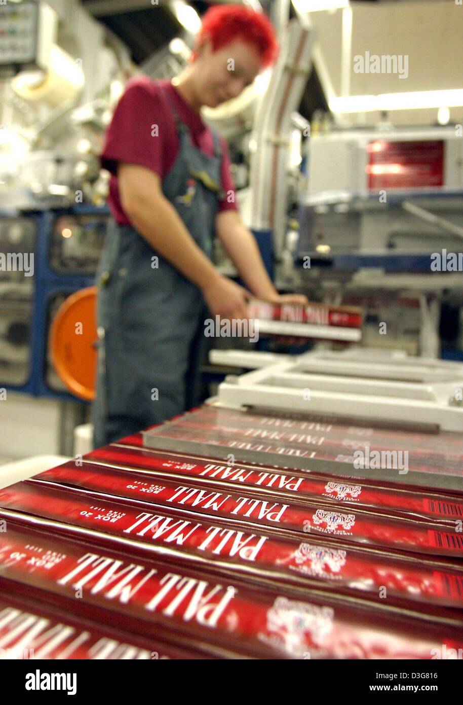 (dpa) - An employee of British American Tobacco works on a packaging line for carton of cigarettes of the brand Pall Mall, in Bayreuth, Germany, 24 October 2003. A carton consists 10 packets of cigarettes. 1,200 employees produce 32 million cigarettes every year. The main brands are Lucky Strike, Pall Mall and HB. Stock Photo