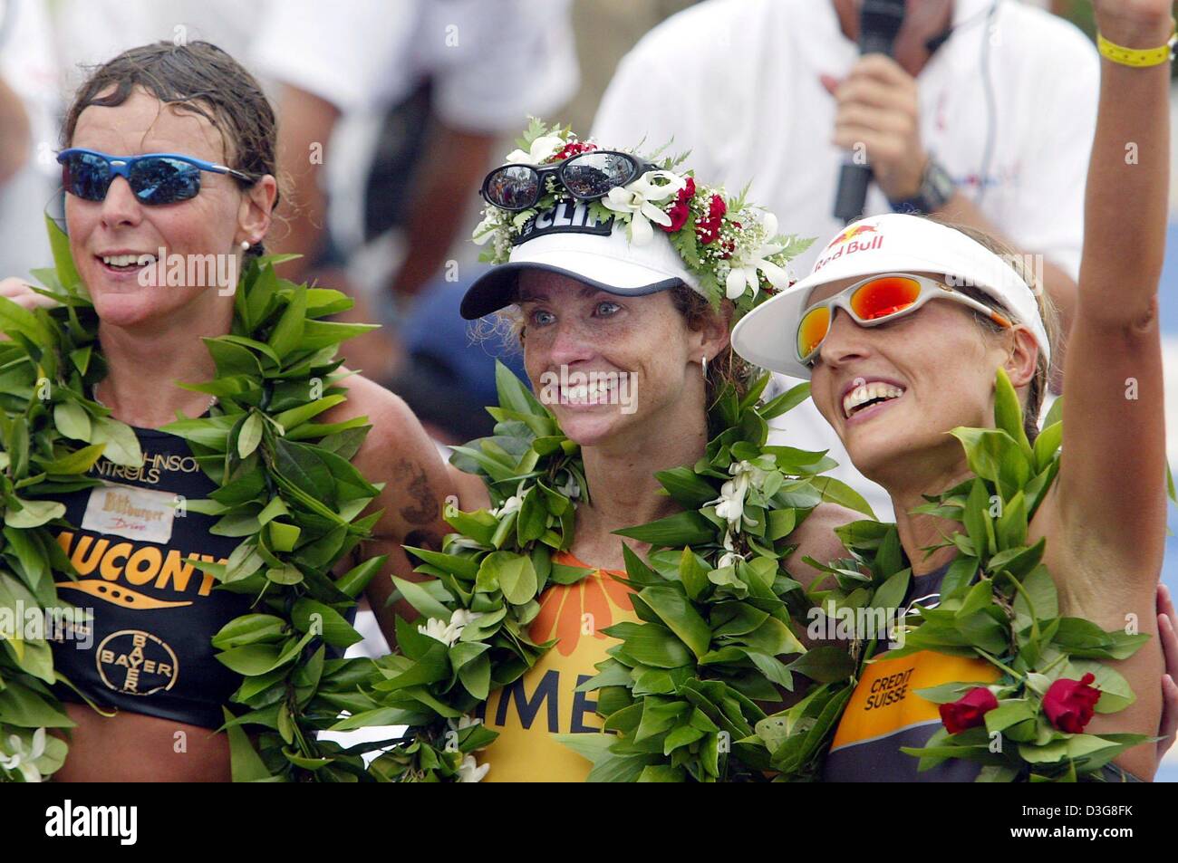 (dpa) - The winners of the women's Iron Man competition, first-placed Lori Bowden from Canada (C), second-placed Natascha Badmann (R) from Switzerland and third-placed German Nina Kraft (L), pose on the podium in Kailua-Kona, Hawaii, 18 October 2003. Bowden won the women's event clocking 9:11:55 hours. The event included 3.8 km swimming, 180 km cycling and a marathon course. Stock Photo