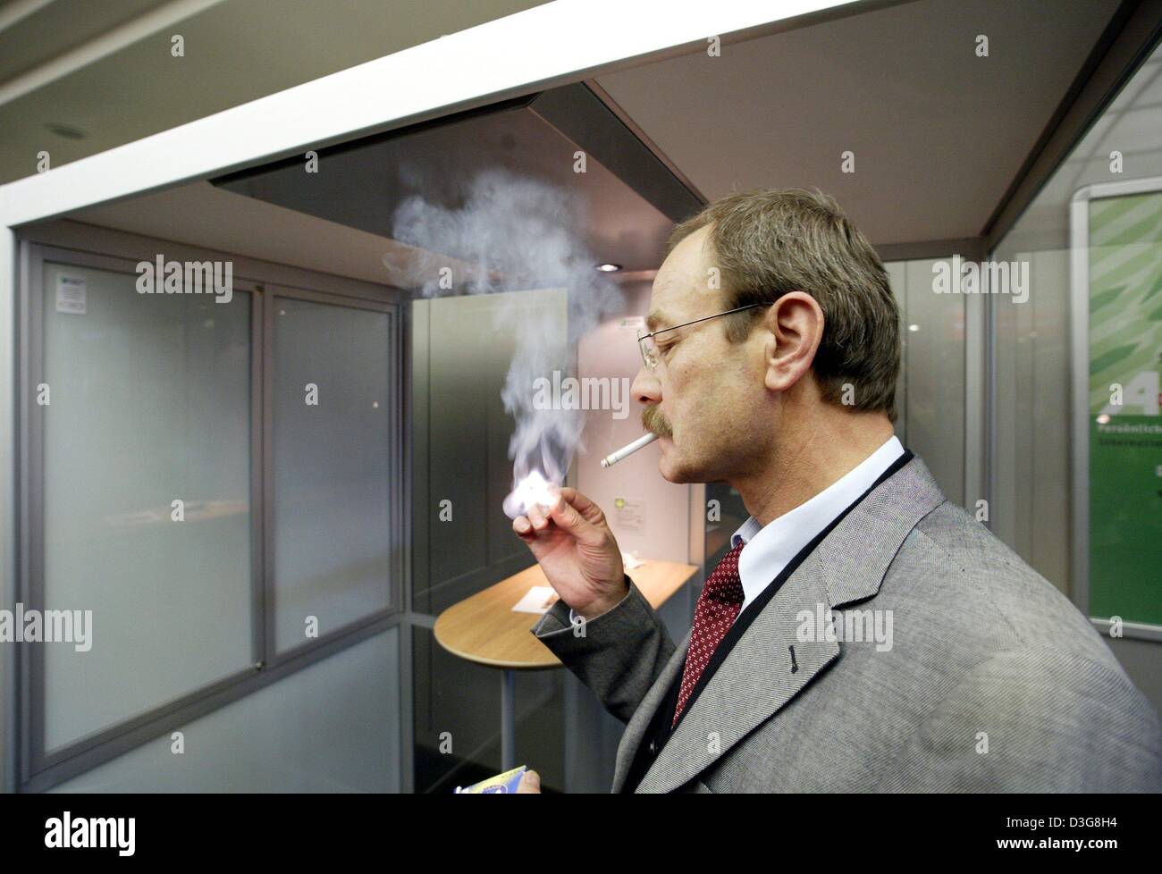 (dpa) A smoker is testing the novel officesmokingstation of the company Smoke Free Systems