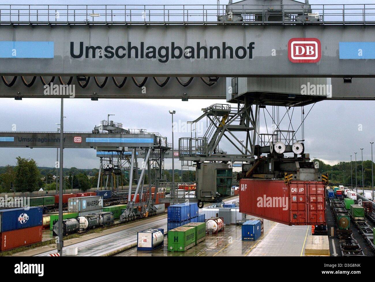 (dpa) - A crane bridge handles container and moves them from a freight train onto a lorry, at the DUSS container terminal in Hamburg, Germany, 23 September 2003. The 'Umschlagbahnhof' (handling train station) is one of the largest in Germany. Stock Photo
