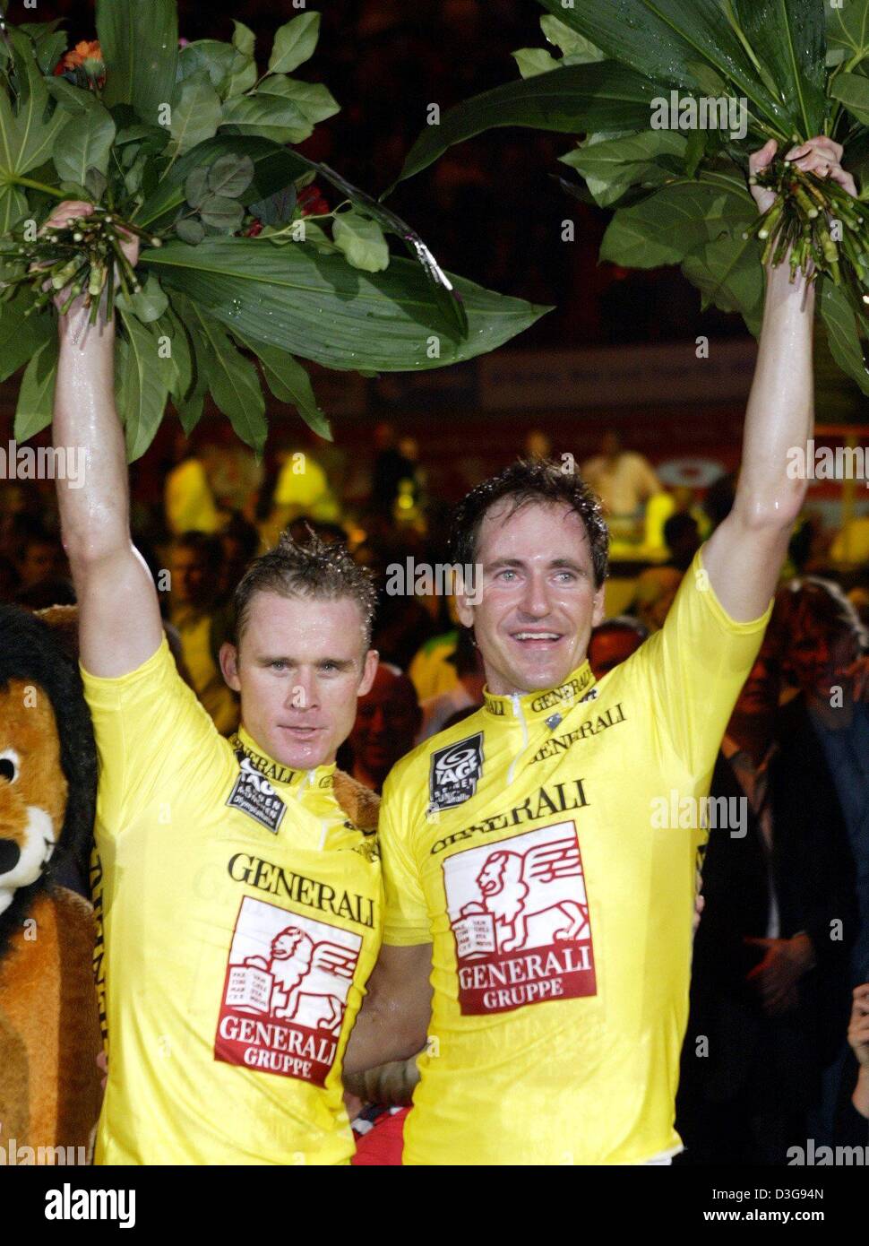 (dpa) - Australian Scott McGrory (L) and Belgian Matthew Gilmore, winners of Munich's 41st six-day-race, wave to the audience in Munich, Germany, late 16 November 2004. Both fought hard for the final victory. Only four points divided the first three teams twenty rounds prior to the end. Stock Photo